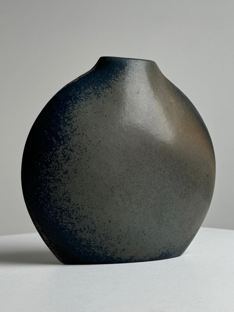 Spherical porcelain vase with speckled dark glaze by Benoît Montreau