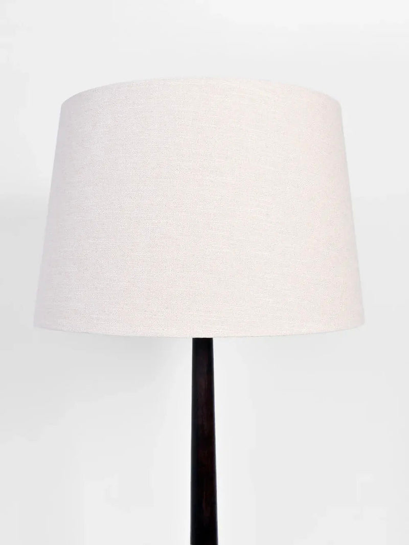 A product by Barracuda Interiors, the Dark Wooden Floor Lamp, 1930s features a minimalist design with a beige cylindrical lampshade and a sleek stand, evocative of 1930s French style, set against a plain white background.