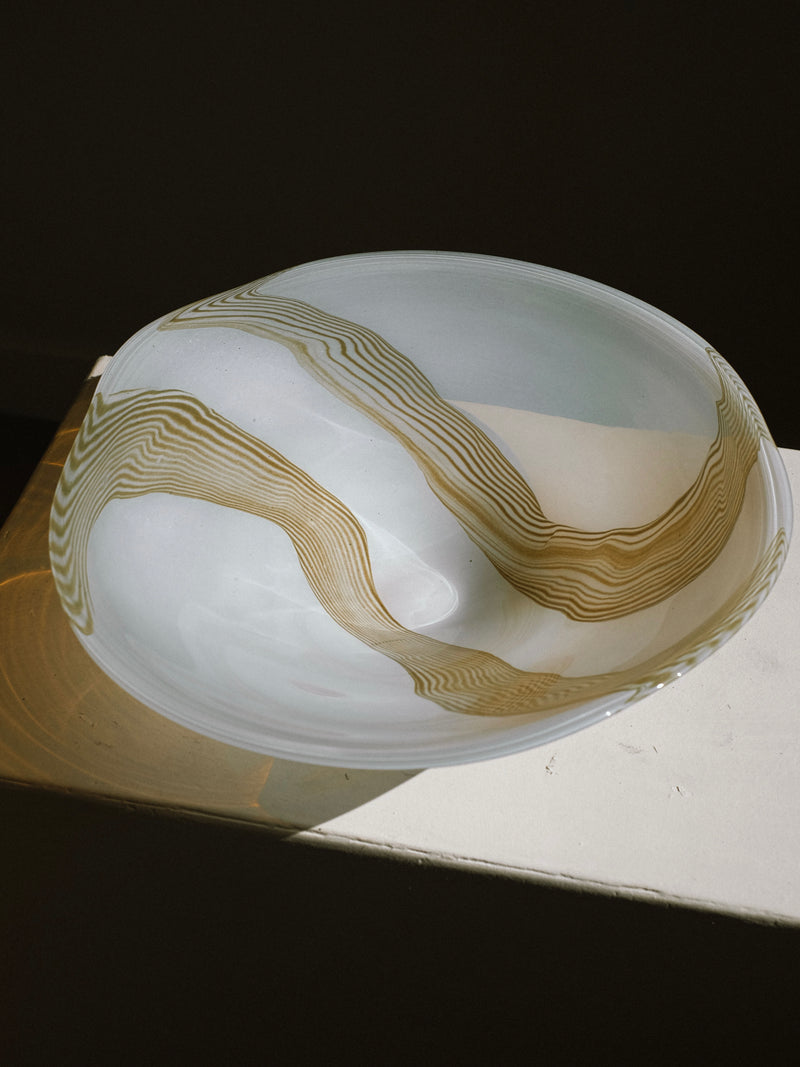 Large blown glass bowl with flowing amber swirl pattern