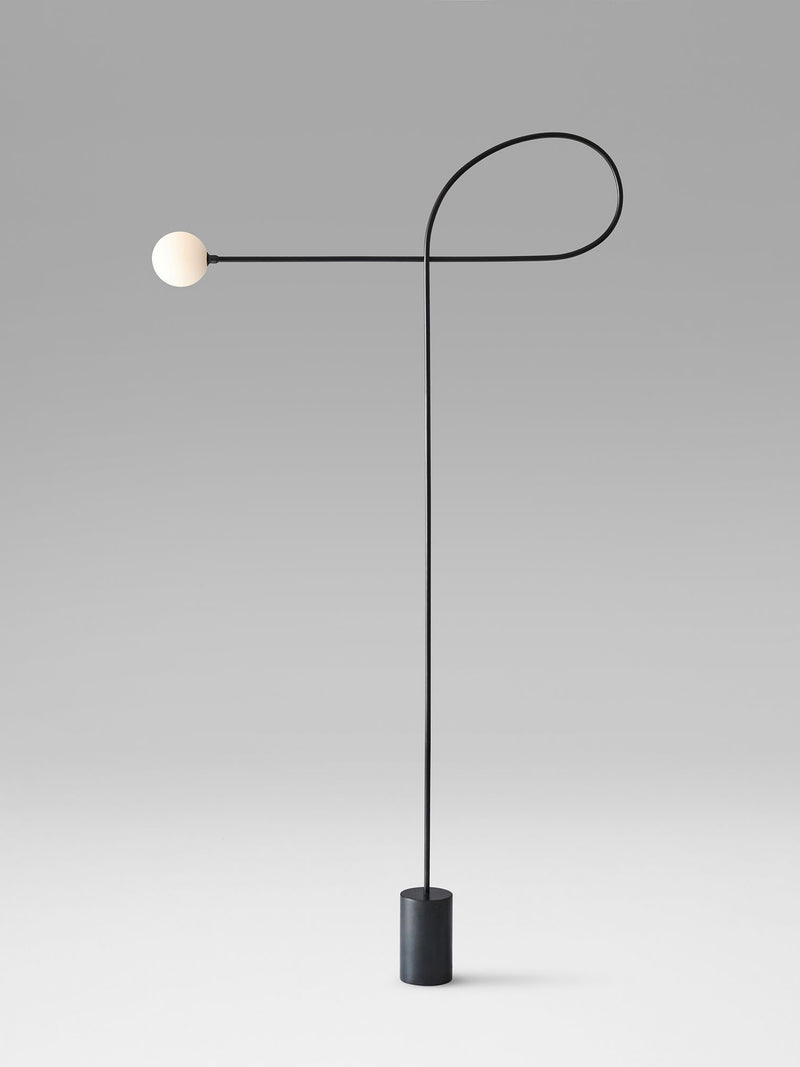 Modern black floor lamp with spherical white shade and curved asymmetrical arm