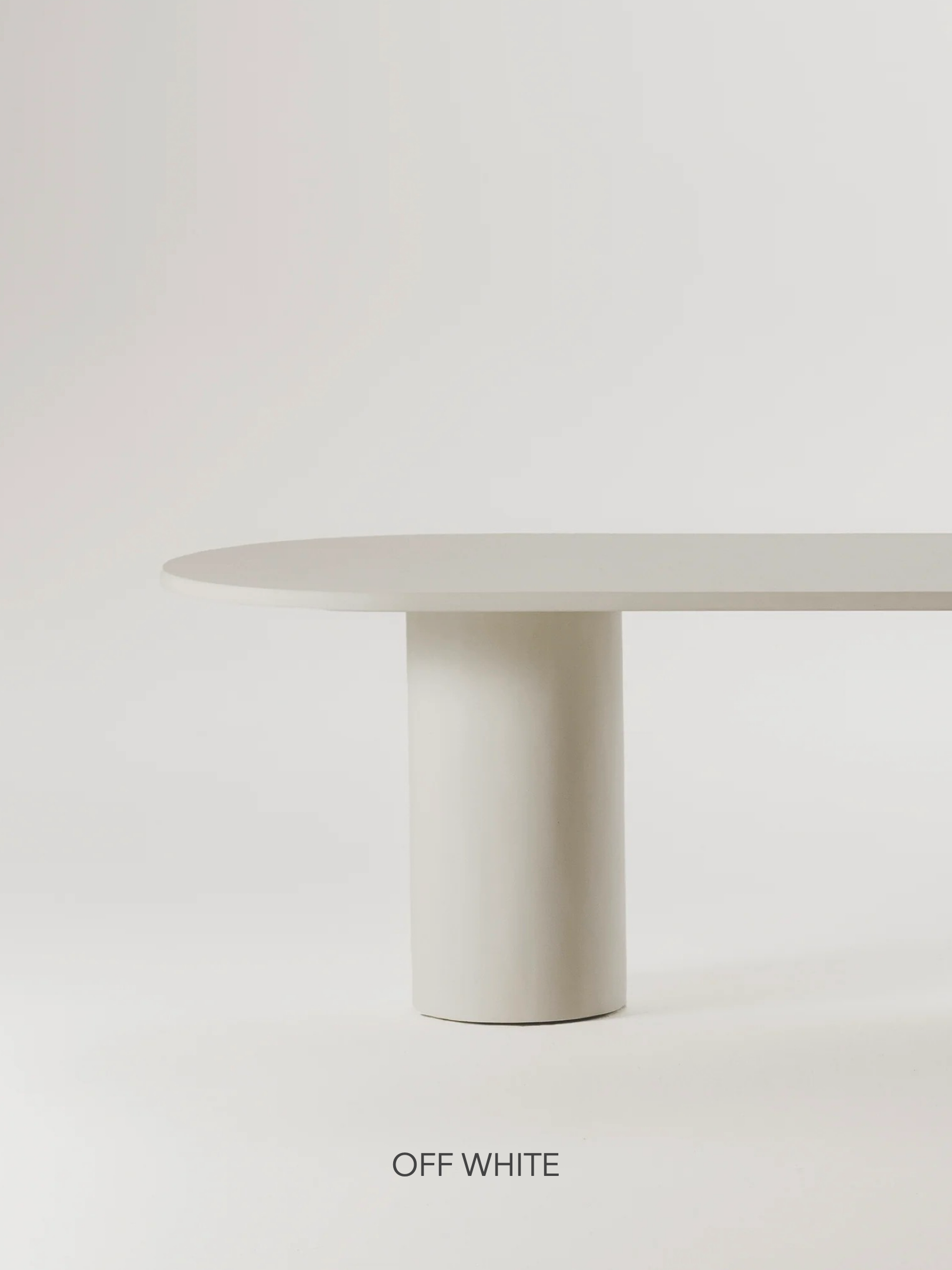 The Gio Dining Table by MarlotBaus is a minimalist beige table, featuring a round top and cylindrical base on a white background, with the words "OFF WHITE" adding to its elegant design reminiscent of a microcement dining table.