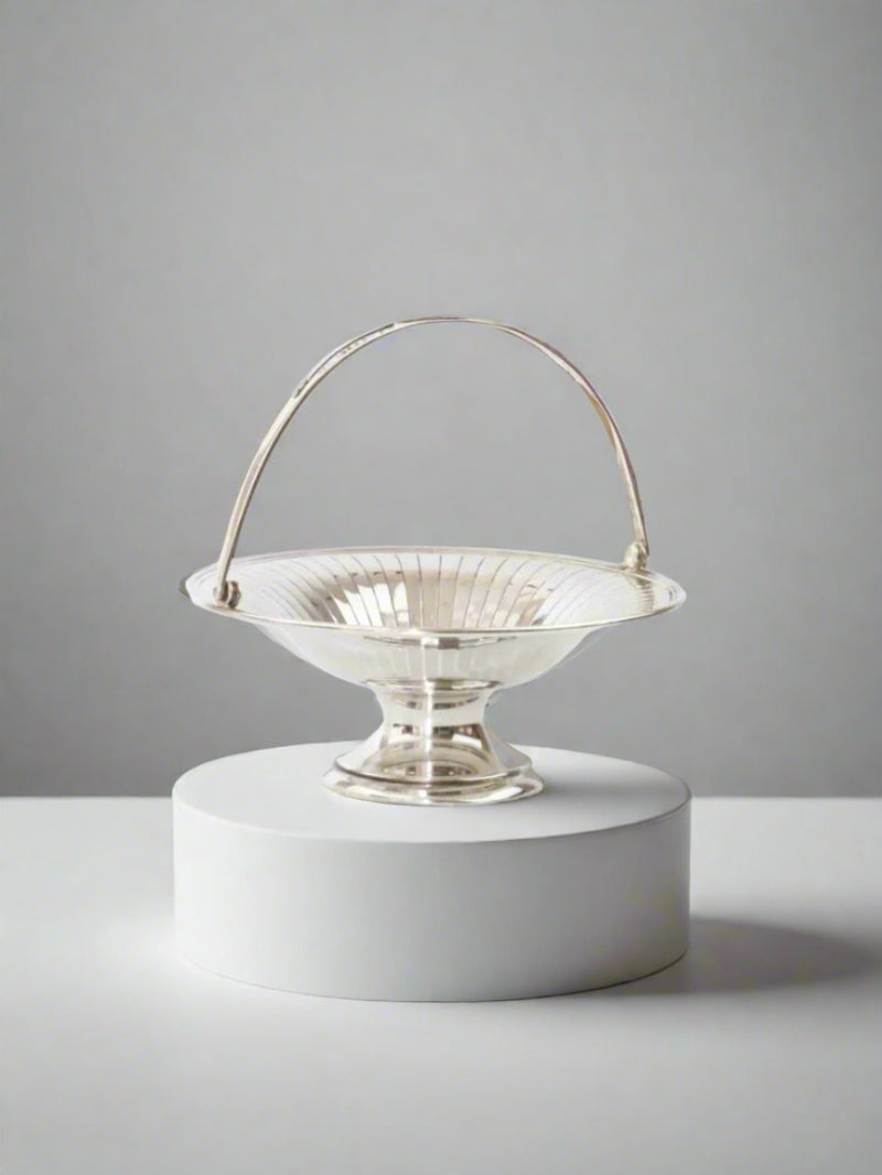 Shiny silver fruit bowl with intricate design, perfect for displaying fresh fruits on a dining table