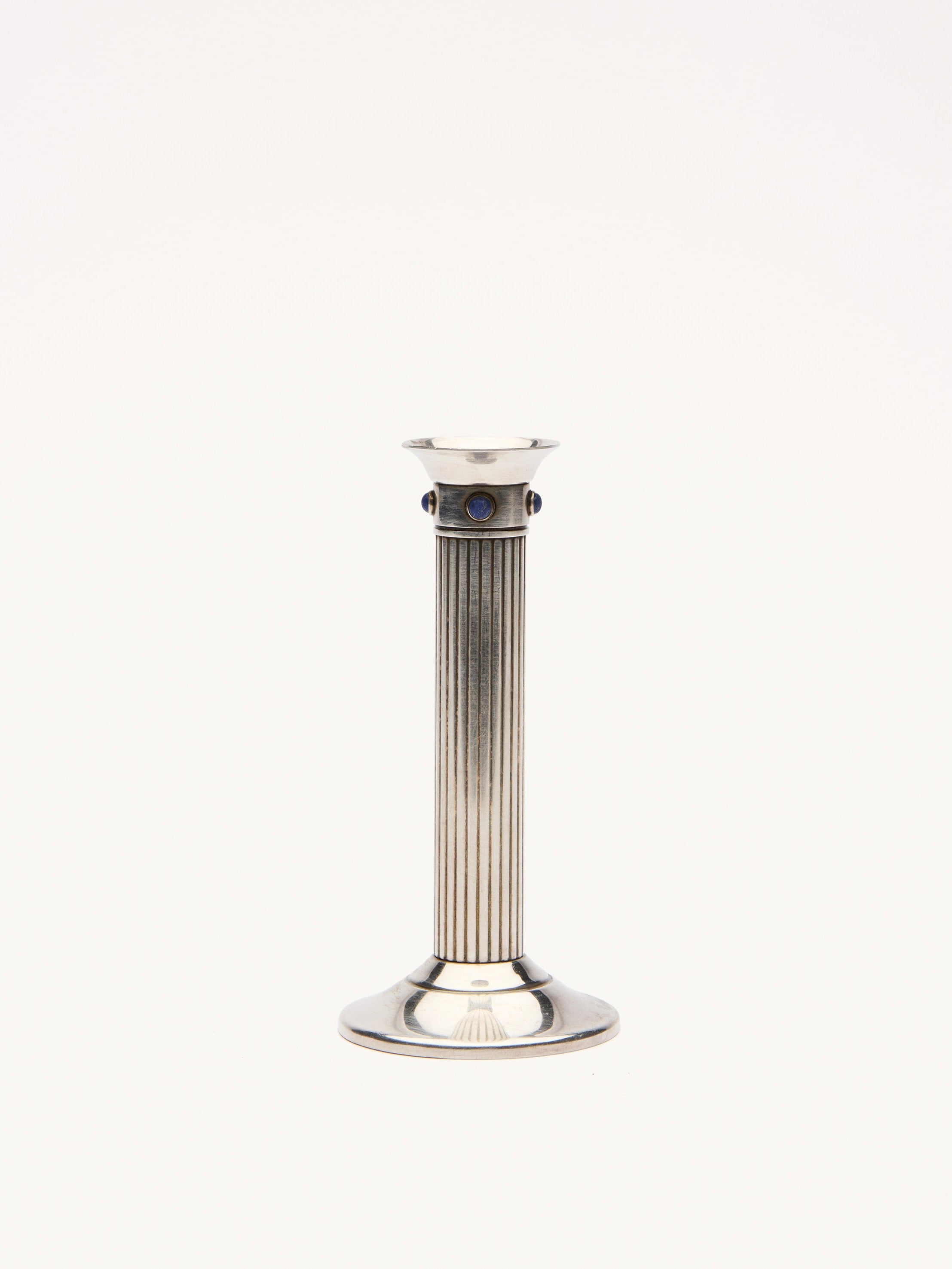 A single silver Galerie MLS Cartier Candle Holder features a fluted column and round base, with lapis lazuli stones near the top, set against a plain white background reminiscent of luxurious design.