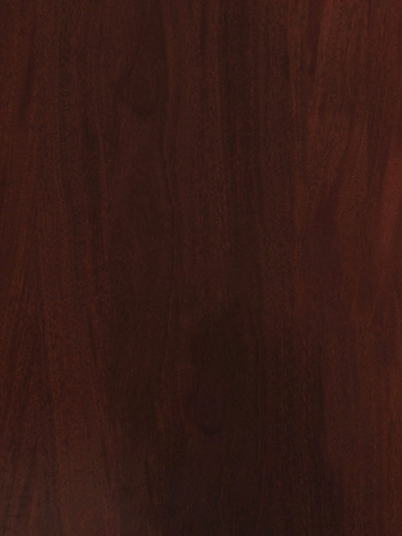 A close-up image of the "Aquarama" Headboard in African Mahogany by Lemon, showcasing its dark brown wooden surface with a smooth, polished finish. The wood grain pattern is visible, featuring subtle variations in shade and texture, subtly accented by mother-of-pearl inlays that add an elegant touch to its natural beauty.