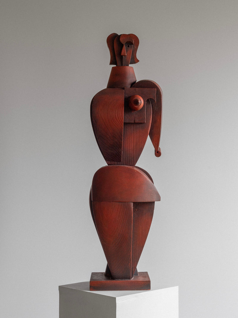 The Vintage Cubist Sculpture II by Atelier Boulogne for Spigel features an abstract, geometric female form on a pedestal. This limited series of eight captures motion and elegance, exemplifying the geometric abstract aesthetic against a neutral backdrop.