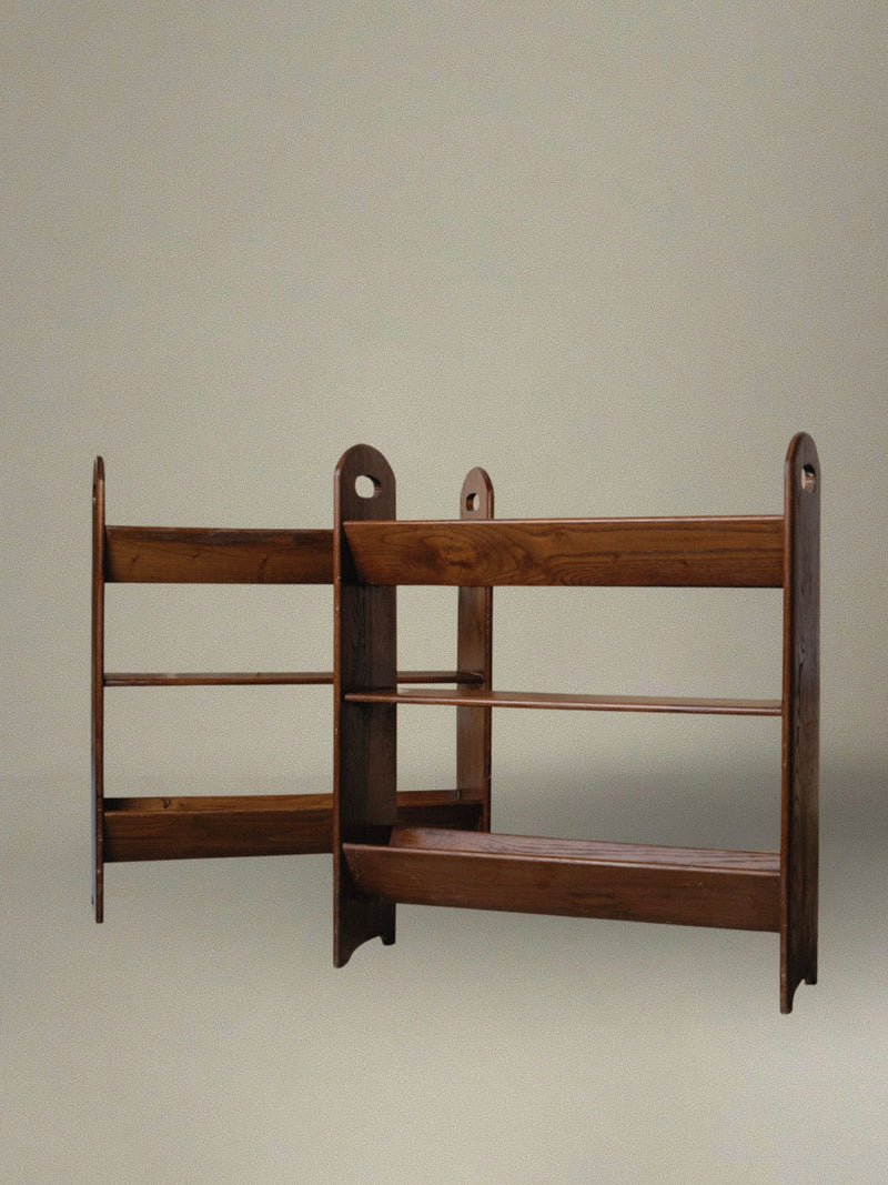 The 2 Vintage Wood Bookcases from Bottega Jacobs, dating back to 1960s Italy, stand side by side against a plain background. They flaunt a simple, open design with three horizontal shelves each, topped with rounded edges and showcasing a warm, natural finish that enhances their dark wood tone.