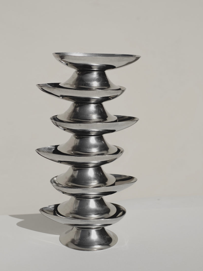 Six stacked polished stainless steel ice coups for serveware