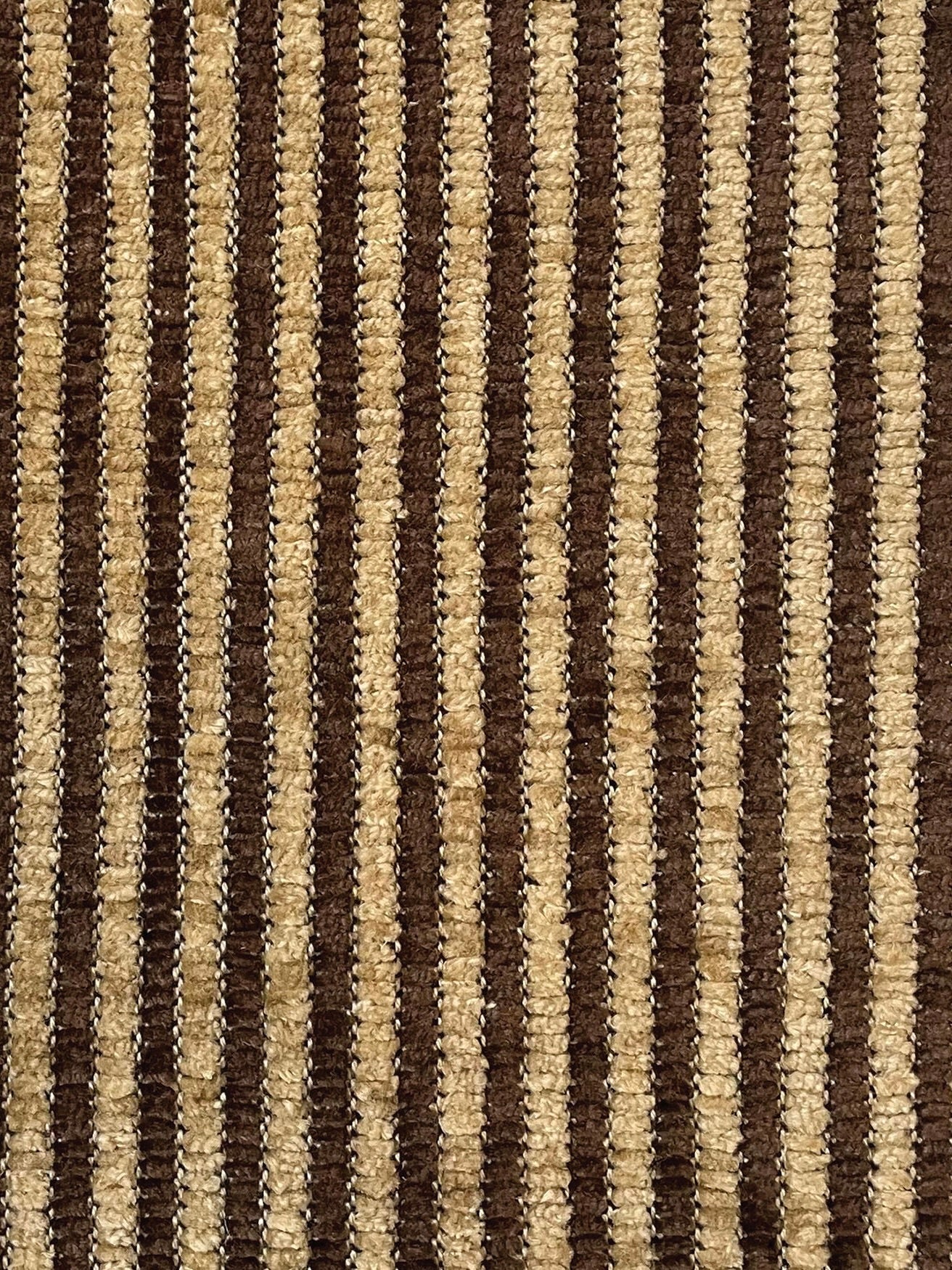 A close-up of the 'Perceptions' Sofa Bench by Known Work reveals a textured fabric with alternating brown and beige vertical stripes. This upholstery-inspired pattern is uniform, adding depth and warmth while reflecting minimalist values.