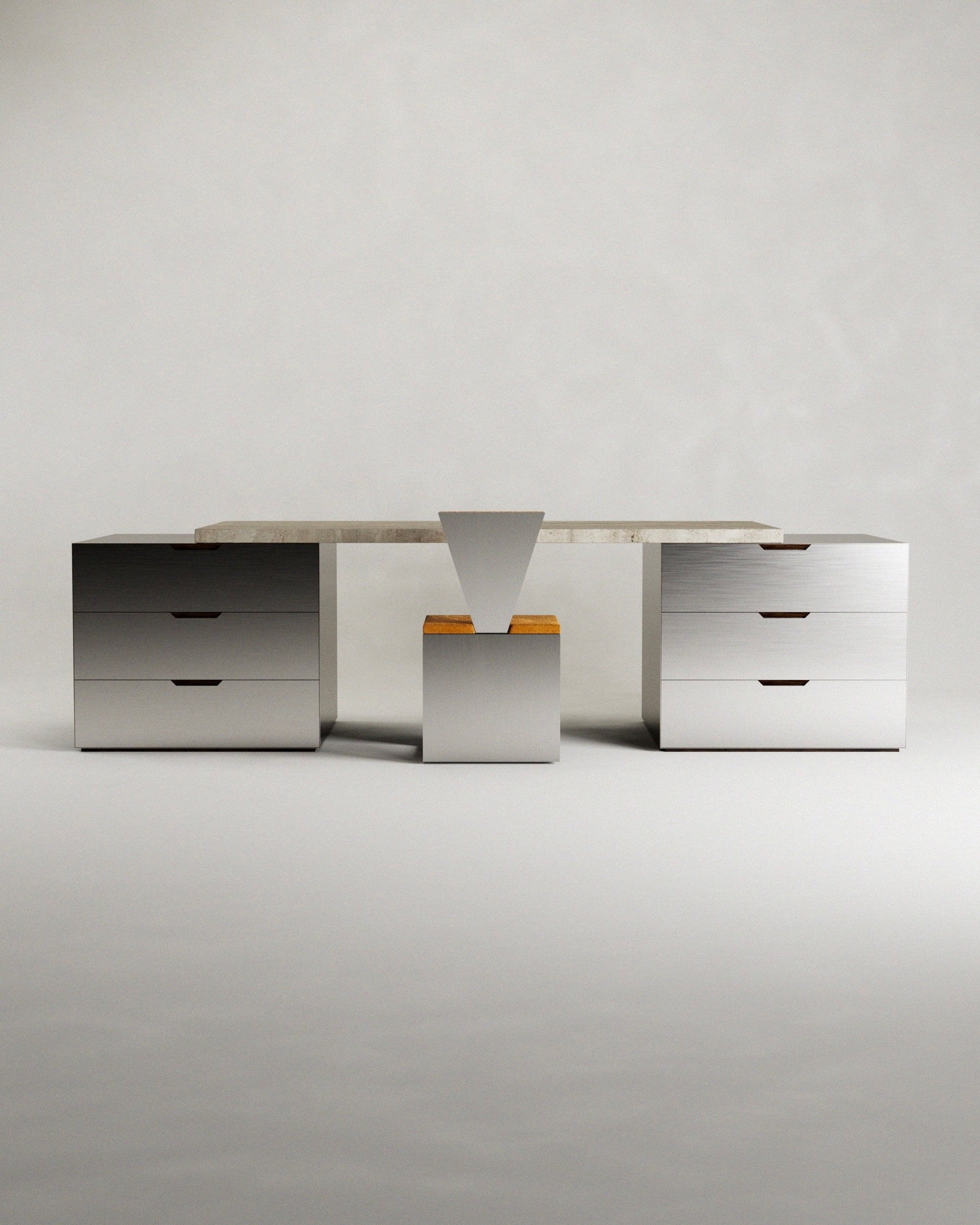 The 'Fragua' desk by Siete Studio features a minimalistic design with a light-colored travertine top, supported by stainless steel drawer units on each side and a triangular support in the middle, complemented by wooden accents in a central unit below.