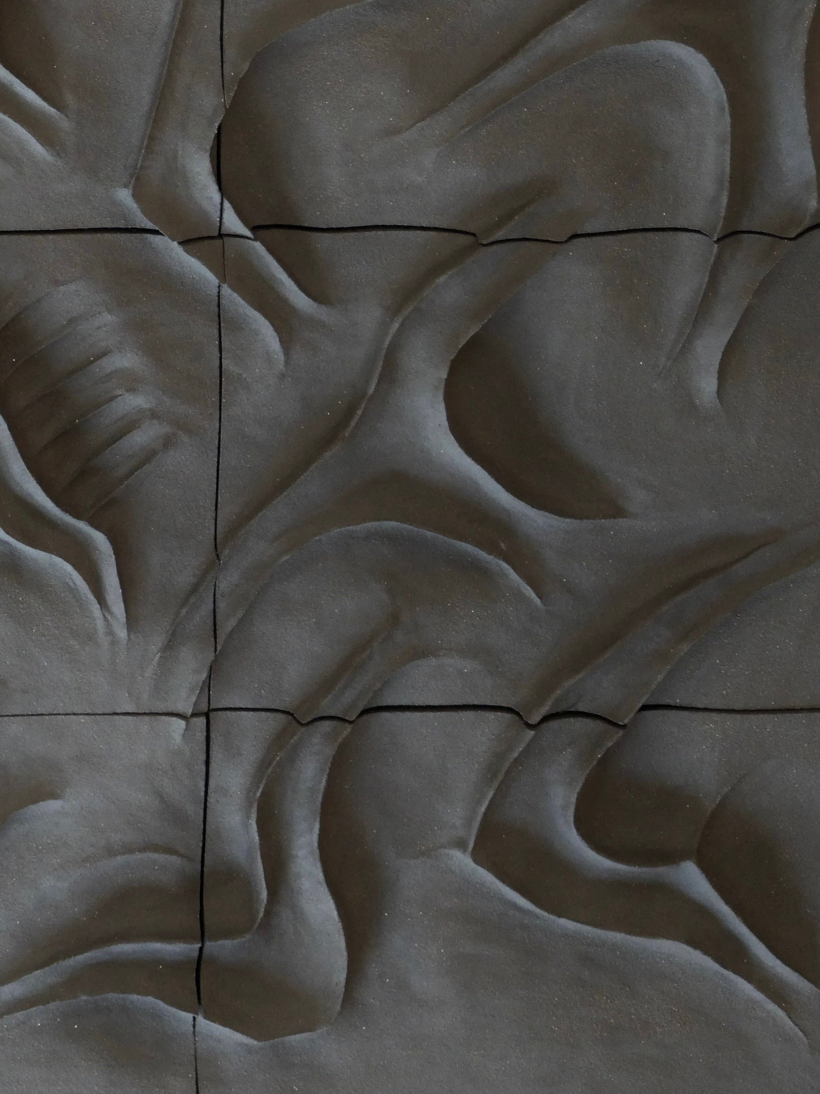 The Caldeira Wall Sculpture by Franck Scala, part of the RELIEFS 2025 Collection, showcases abstract wavy patterns like draped fabric. This textured ceramic bas-relief features soft curves and shadows for depth, with thin intersecting lines creating dynamic sections.