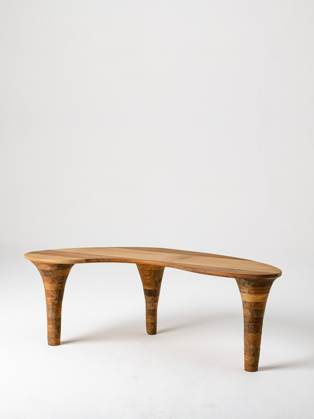 Curved organic coffee table with sculptural wooden legs