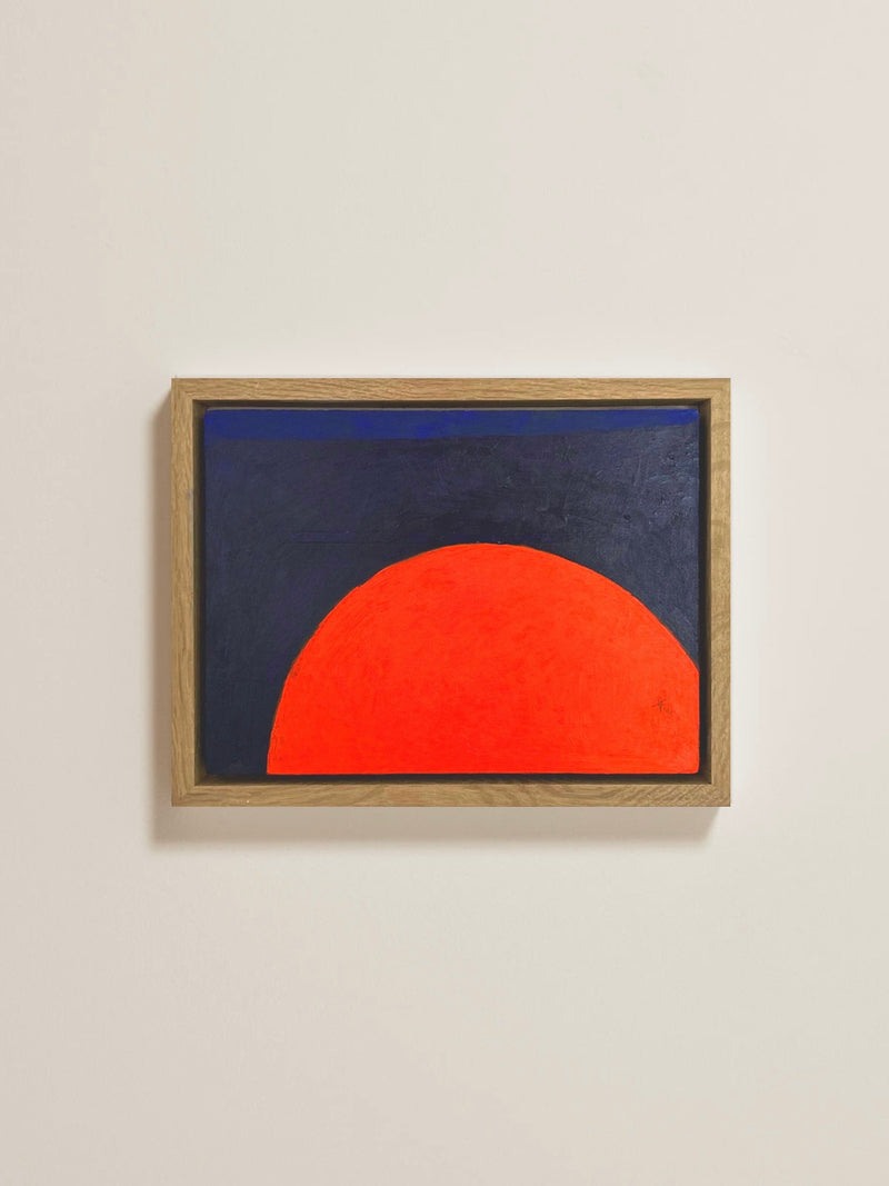 The 'Sunday Morning' painting by Lara Voce features a bold red semicircle on a dark background, displayed on a light wall. It is framed in a solid oak frame made of light wood, which contrasts beautifully with the vivid acrylic colors.