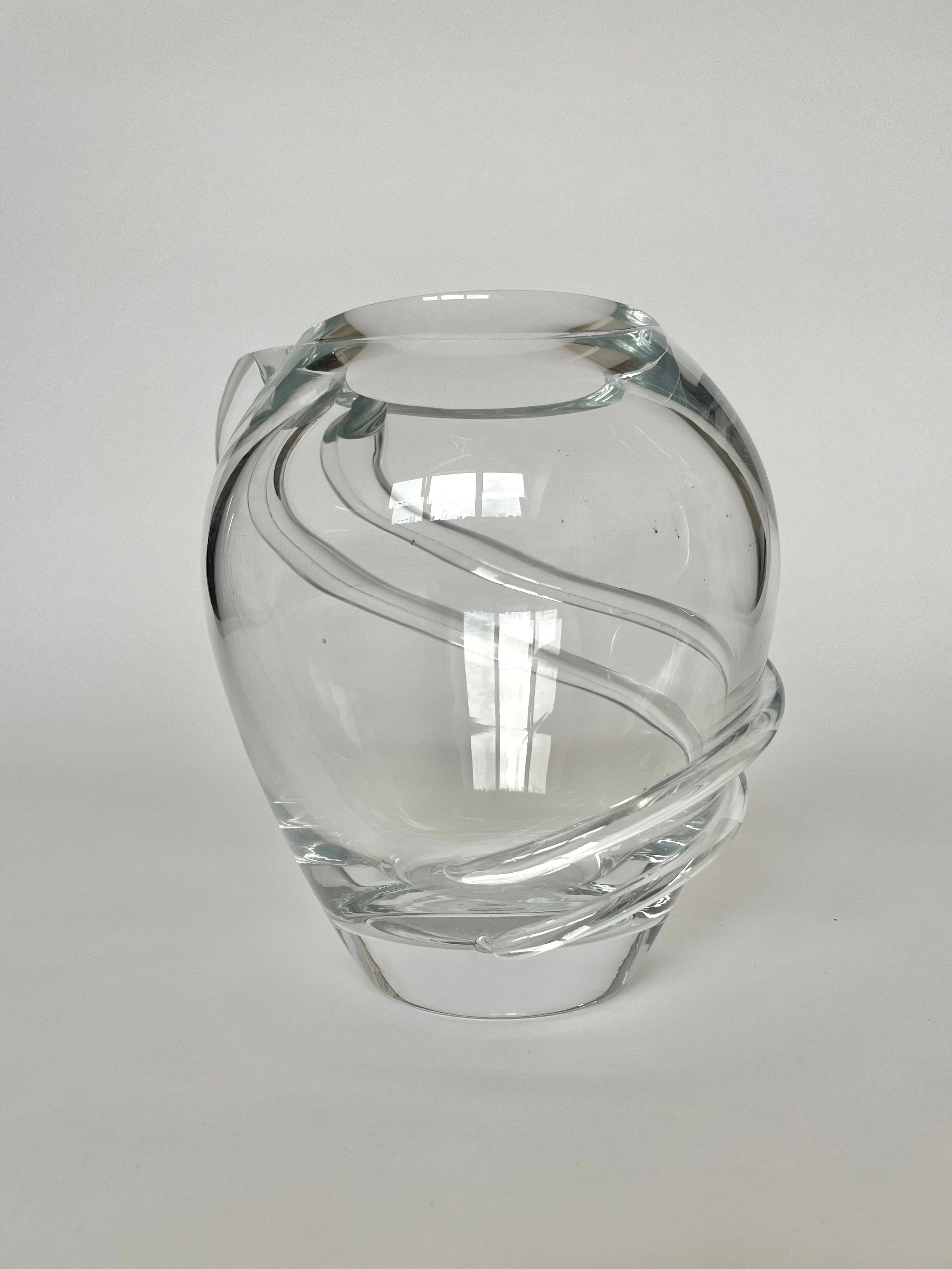 A clear, rounded Vintage Crystal Vase by septembre studios features a stunning spiral design gracefully wrapping around its exterior, set against a plain white background.