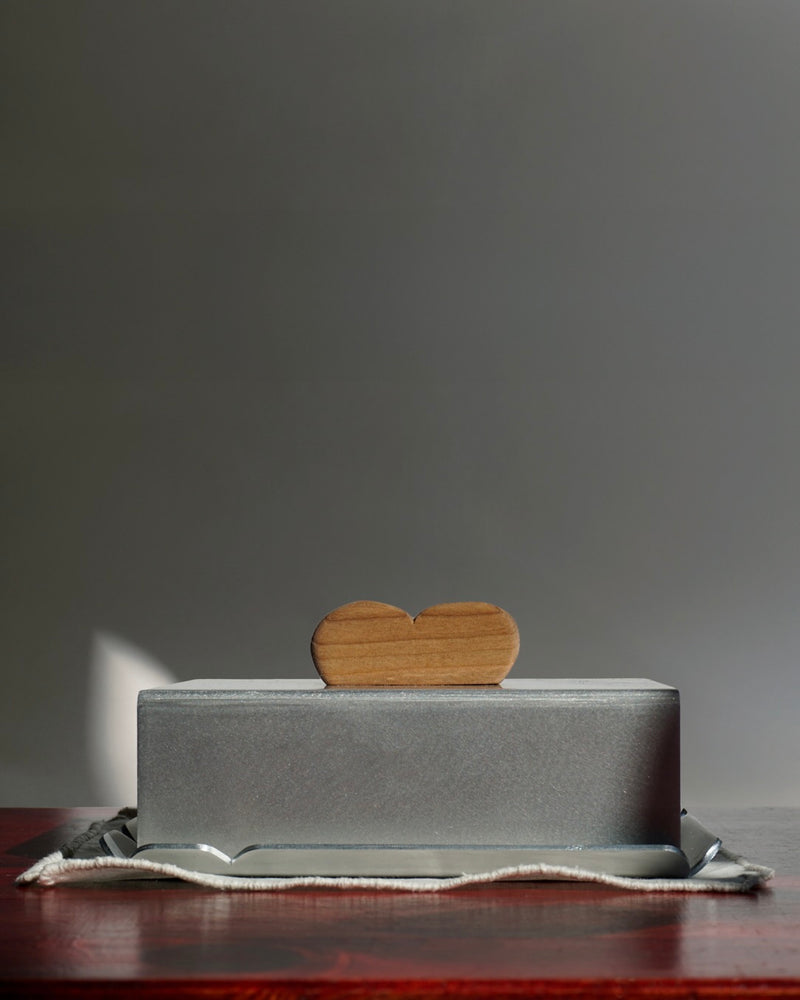 Modern stainless steel butter dish with wooden heart-shaped handle