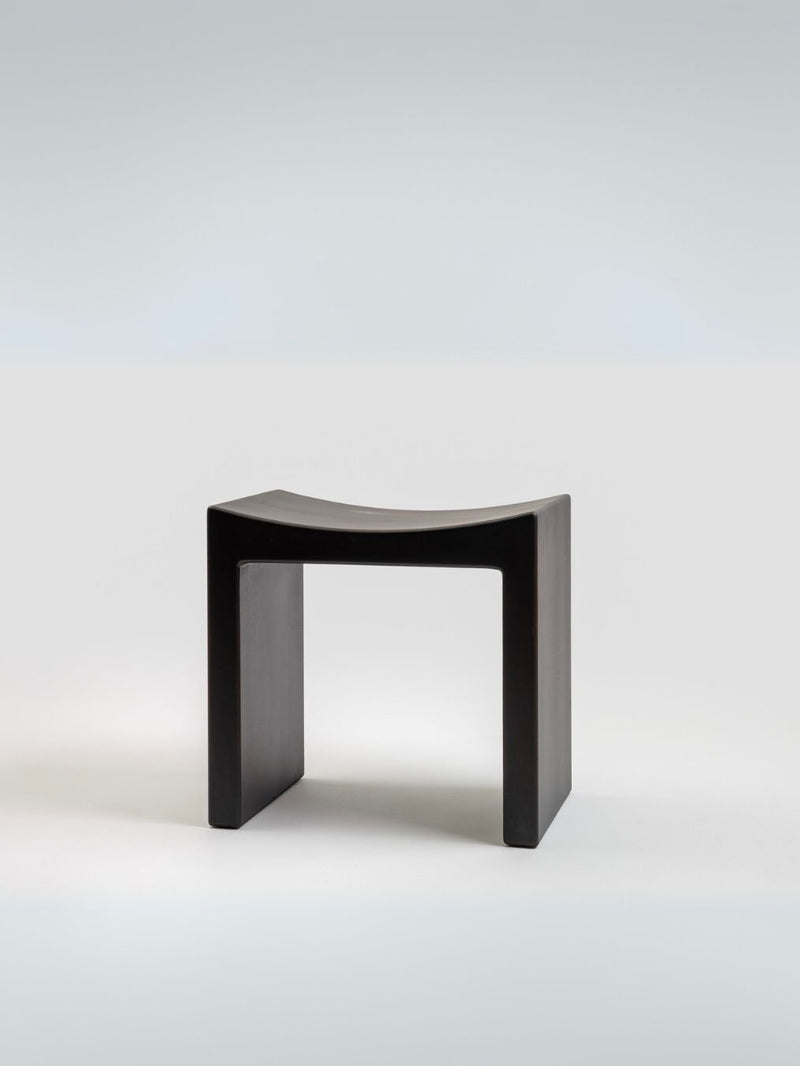 Modern black wooden stool with curved seat by Giuseppe Rivadossi