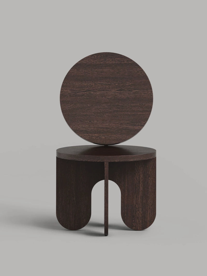 Dark wood chair with circular backrest and arched base design