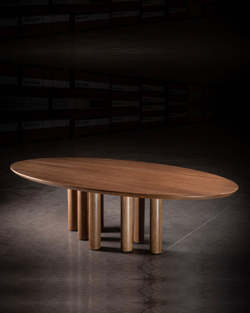 Modern oval walnut dining table with cylindrical legs by No Age Studio