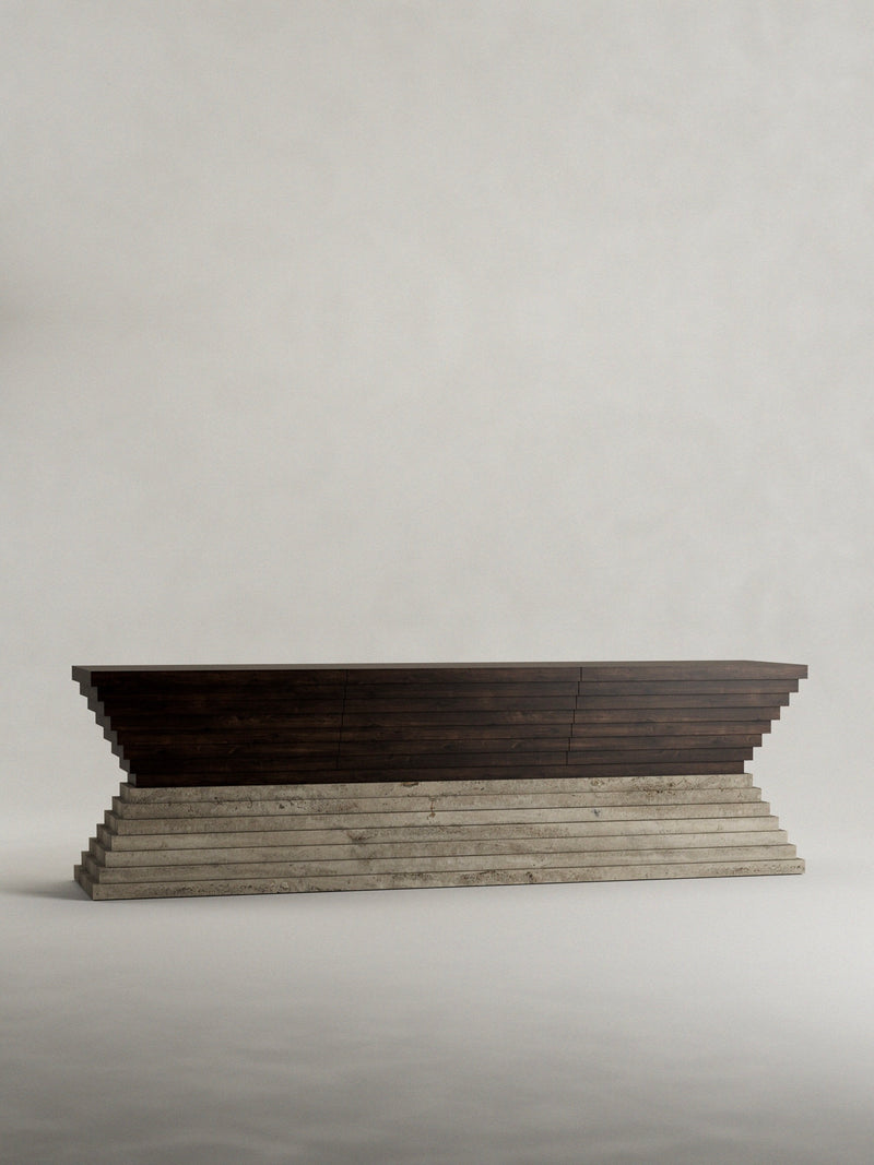 The "Calakmul" Sideboard by Siete Studio is a long, dark wooden console table with a solid walnut top and stepped design, featuring tiered geometric shapes atop a textured travertine base against a plain, light background.