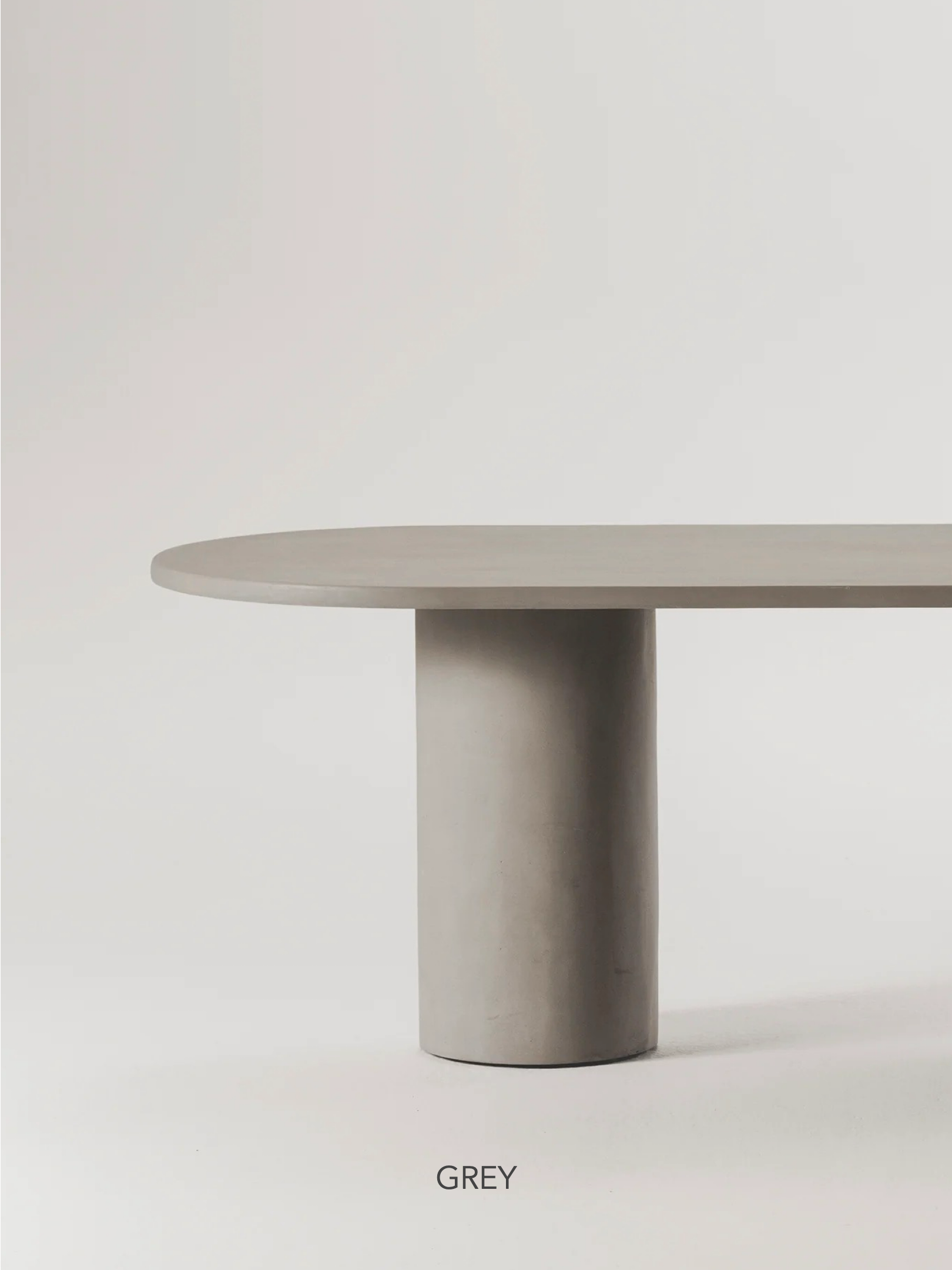 The Gio Dining Table by MarlotBaus boasts an elegant design with a cylindrical base and an oval-shaped top on a light background, with "GREY" printed below for minimalist sophistication.