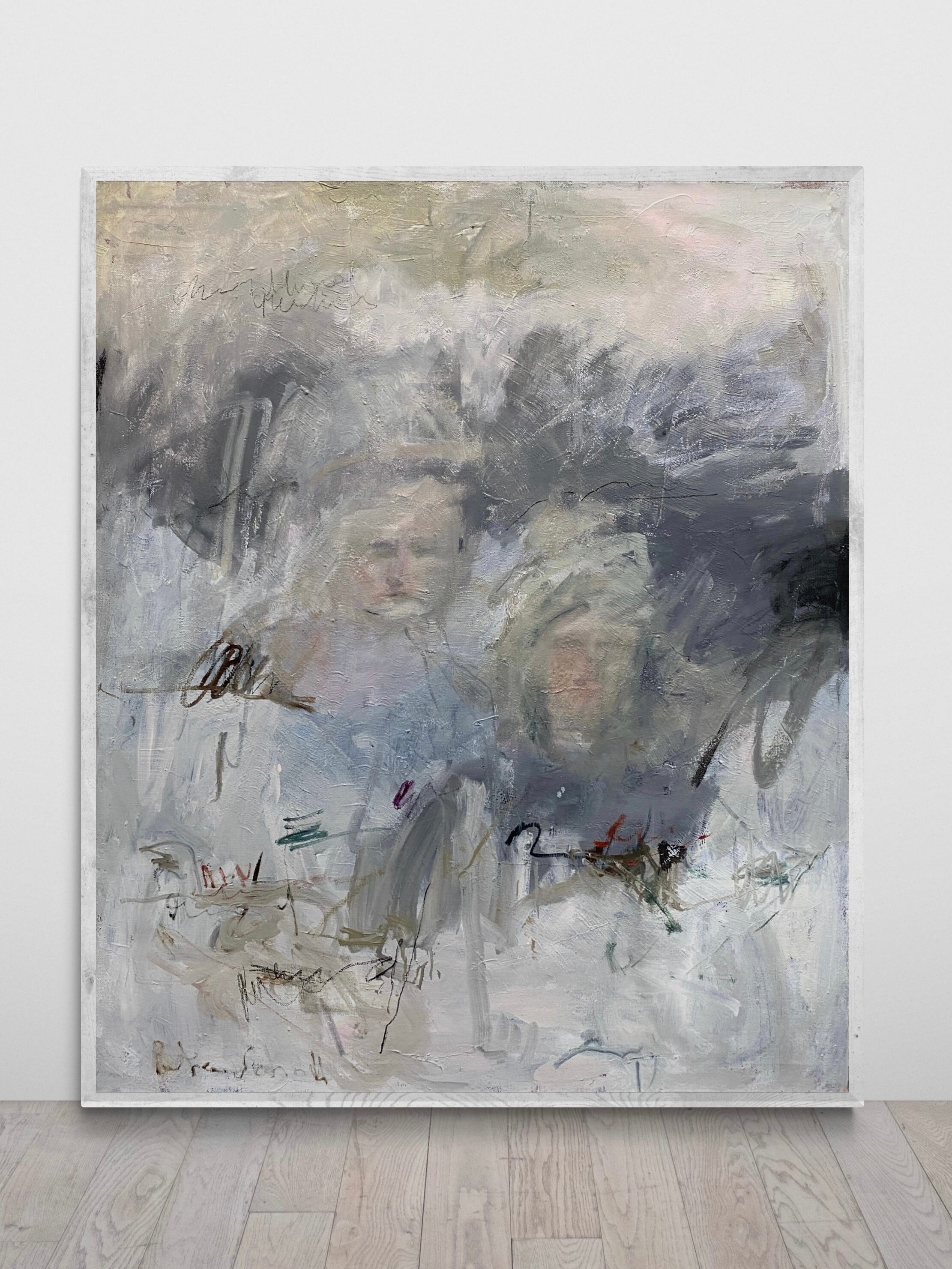 Petra Schott's "Memory's Veil" is a textured oil painting on canvas featuring abstract faces and human figures. It uses muted shades of gray, white, and beige with dynamic scribbles and markings on a swirl-brushed surface, set against a simple light wall evoking memory.