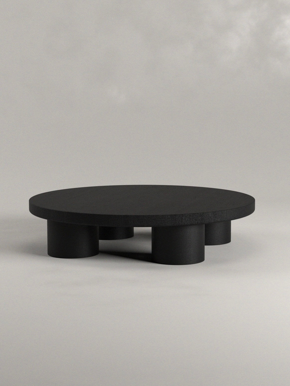 Explore the Totem Coffee Table by Siete Studio, a handcrafted gem with a modern, low-profile design. It features a round top and solid walnut cylindrical legs of varying heights against a light gray background for a minimalistic contemporary look.