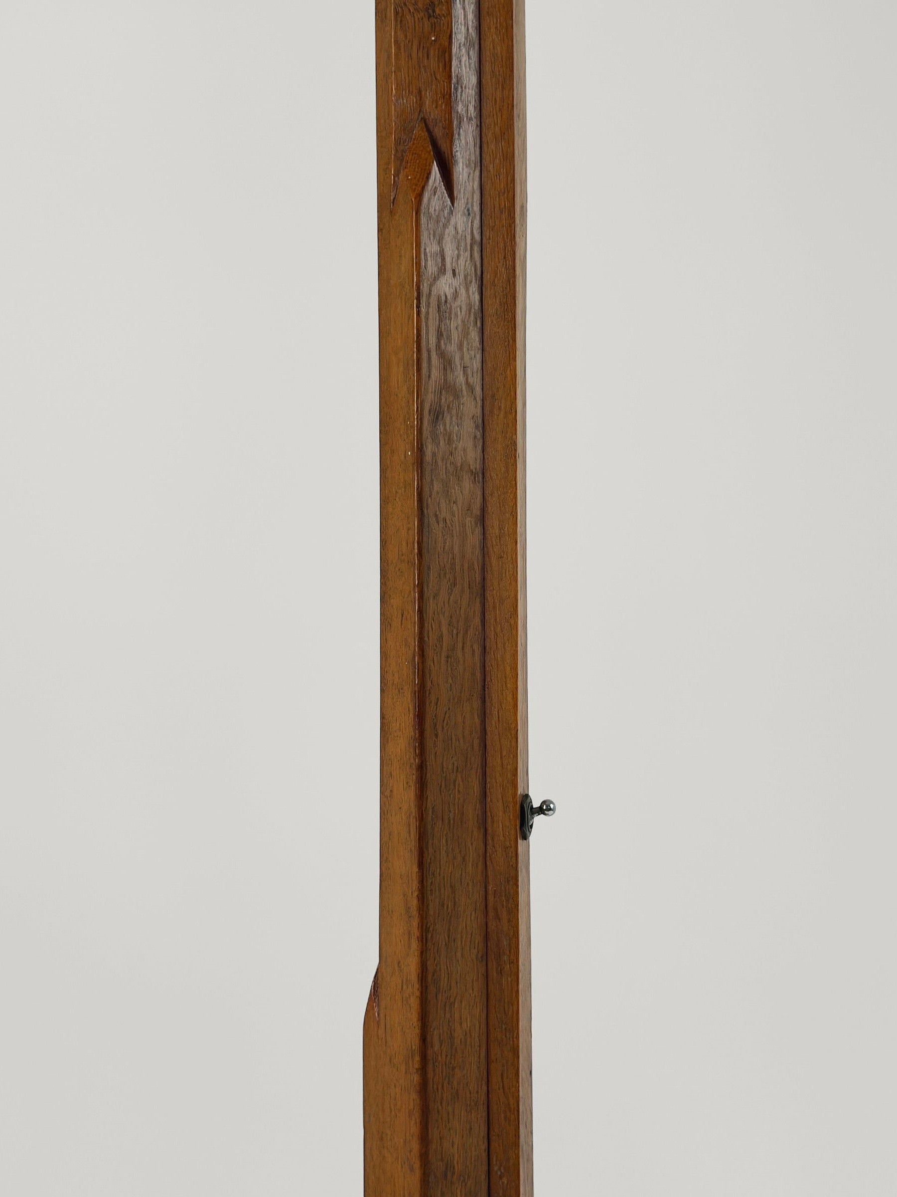 A close-up view of a section of the Figuresdesign Art-Deco Floor Lamp, showcasing its smooth, light to medium brown carved wood with a vertical orientation. The image features a small key inserted into an intricately designed keyhole. The background is plain white or light gray, highlighting the elegant details of this exquisite floor lamp.