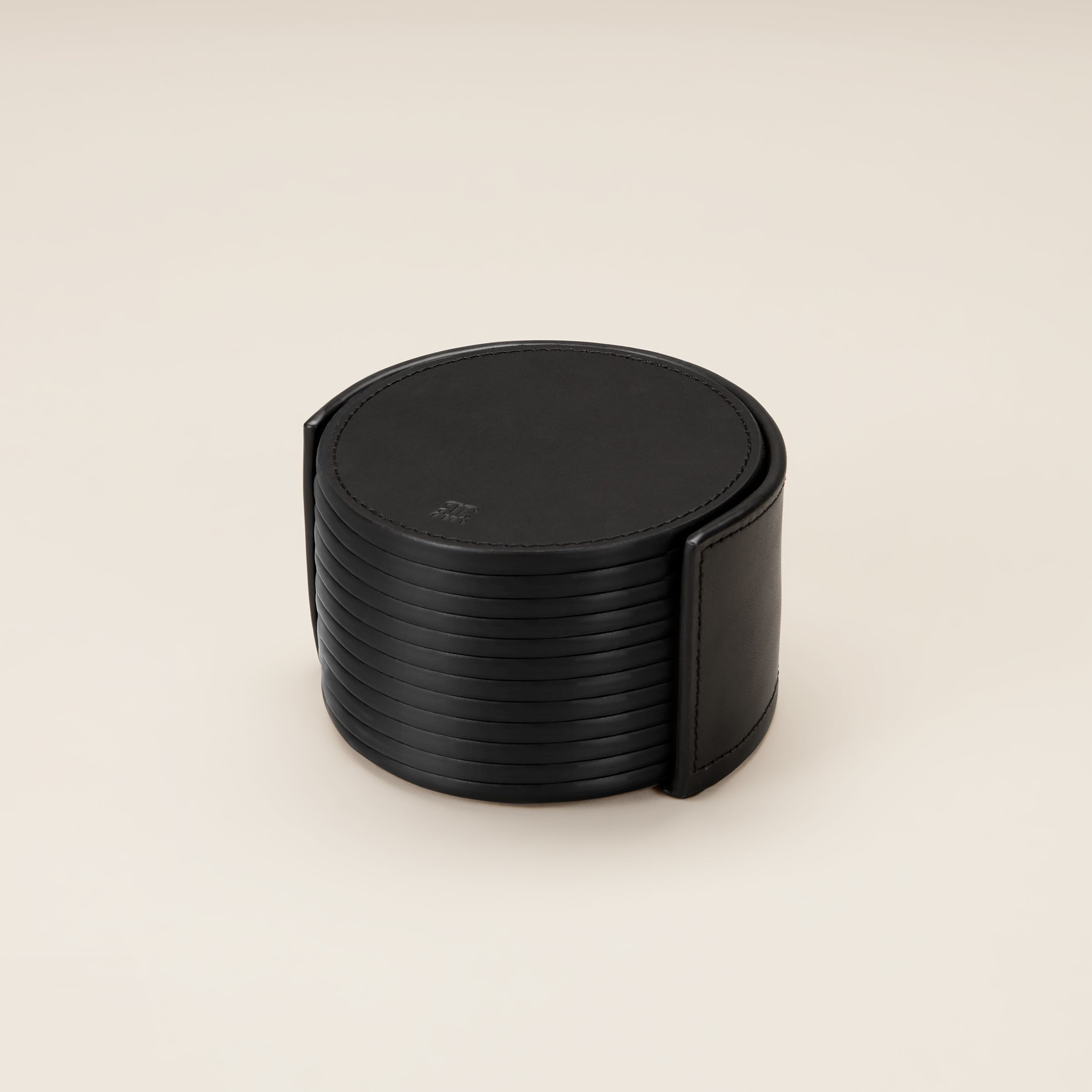 Leather Coasters in Holder (set of 12) — top view of black leather coasters in holder