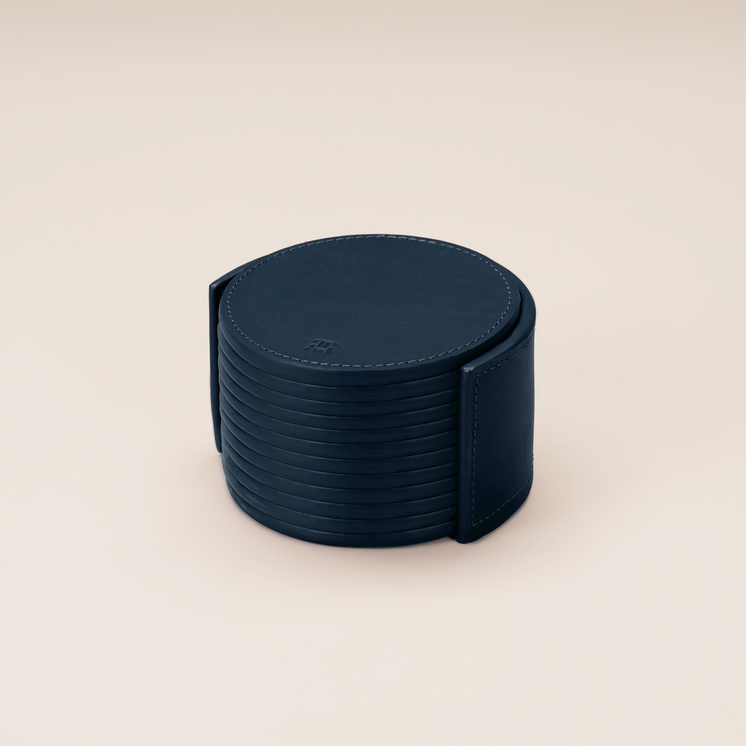 Leather Coasters in Holder (set of 12) — top view of navy leather coasters in holder
