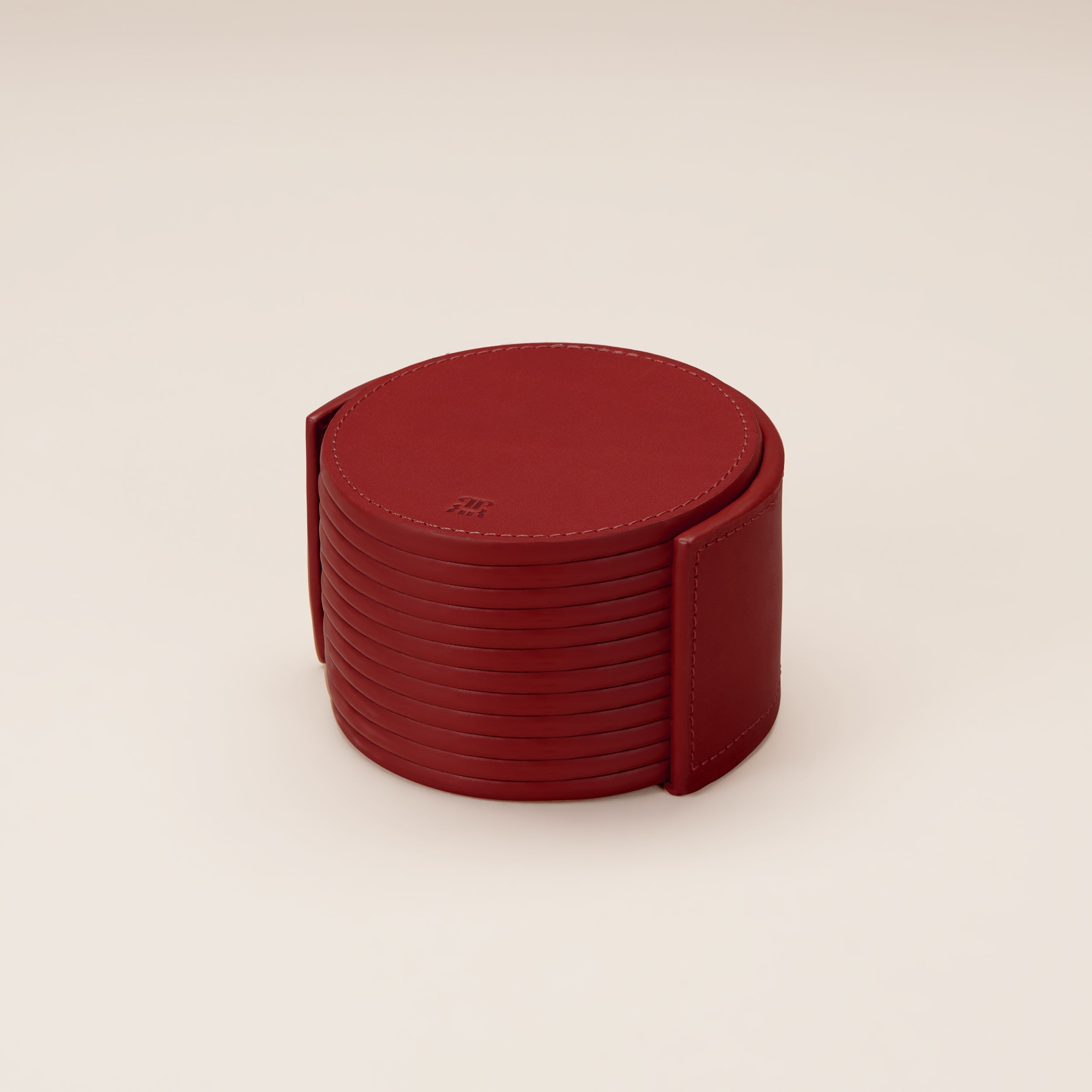 Leather Coasters in Holder (set of 12) — top view of red leather coasters in holder