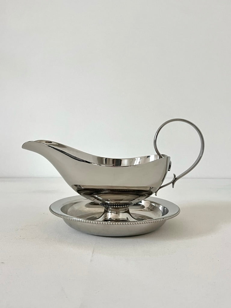 Silver gravy boat with beaded saucer on matching plate