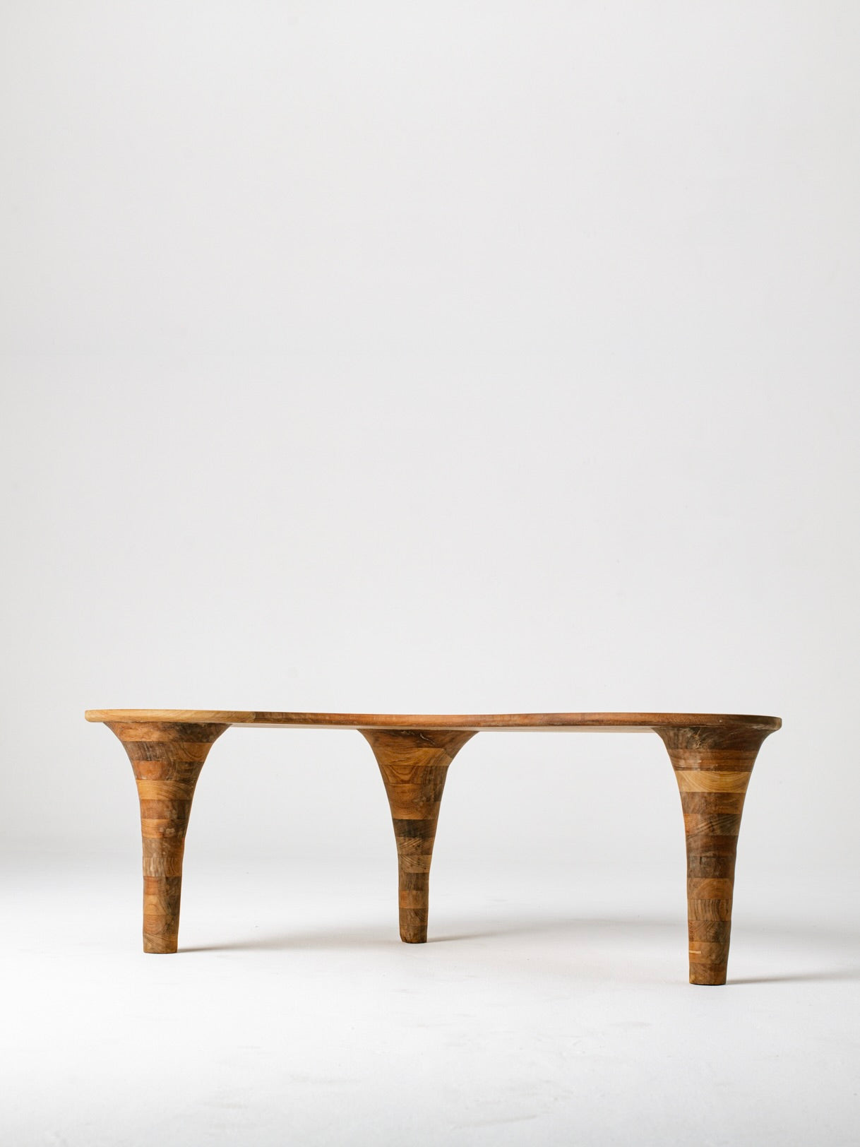 Organic wooden coffee table profile view showing curved legs