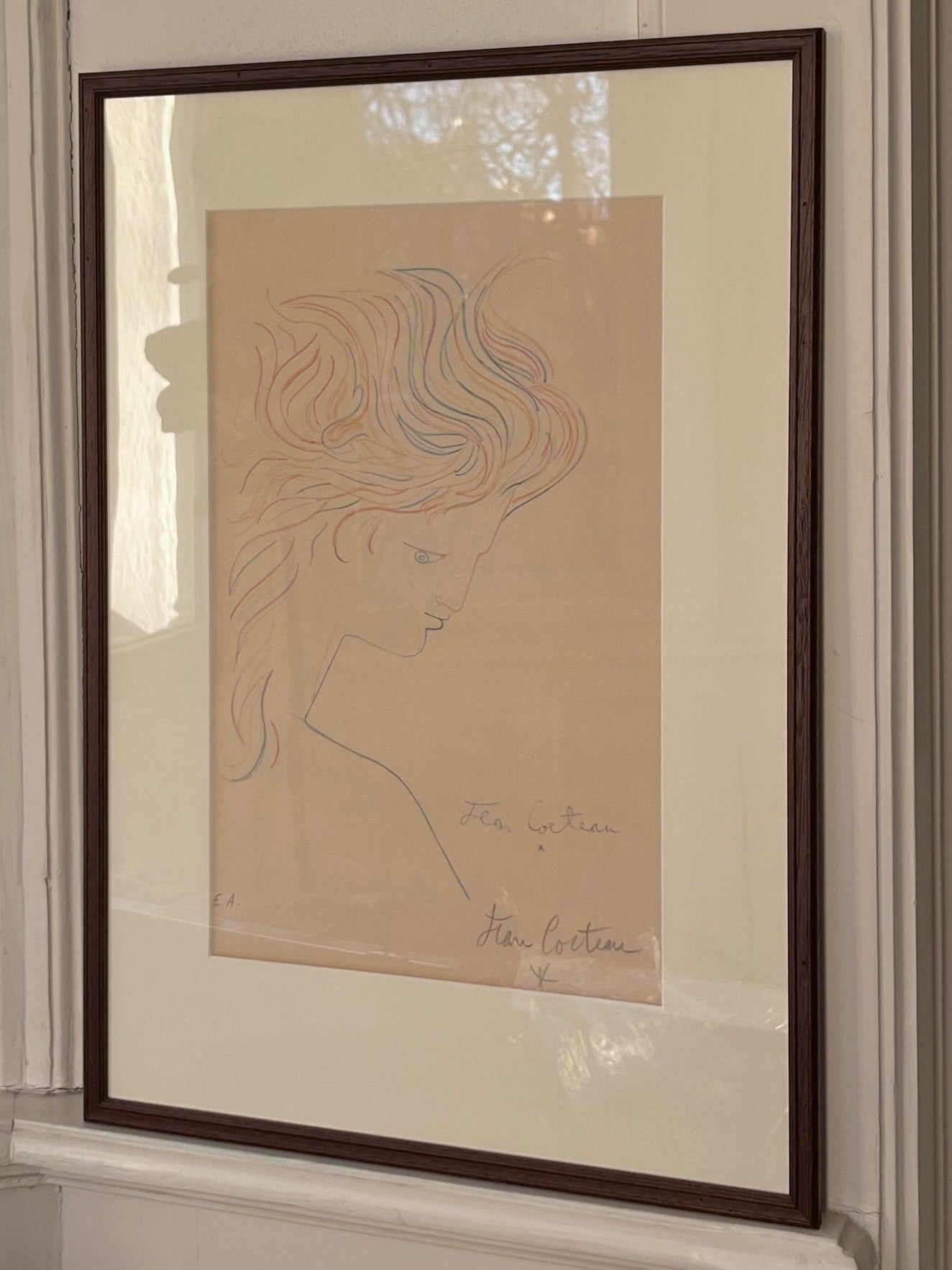 The Jean Cocteau Signed Lithograph by Médecine showcases a minimalist line drawing of a woman's profile with flowing hair, elegantly signed in pencil at the bottom, capturing simplicity and grace.