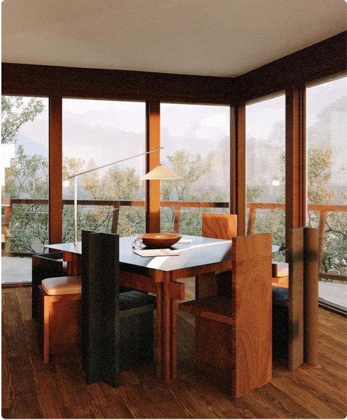 Contemporary dining room with a wooden table and chairs, surrounded by large windows offering a view of a lush green landscape.