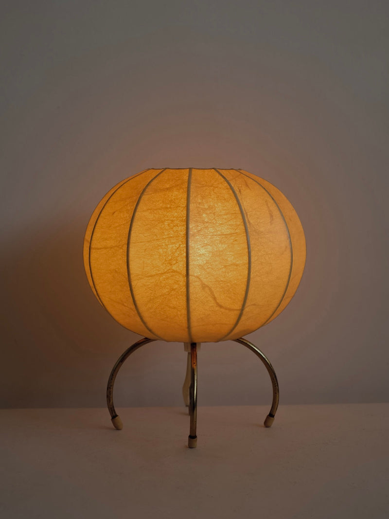 Orange paper cocoon table lamp on brass tripod base by septembre