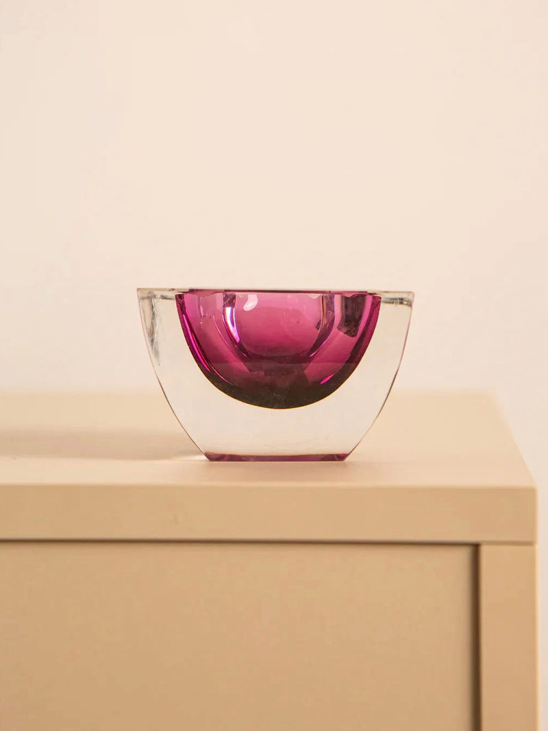 A Square Pink Crystal Ashtray by Val St Lambert 80's from Treaptyque sits on a light beige surface. Its small, modern glass design, with a clear exterior and pink crystal-like appearance, blends seamlessly into the matching beige background, evoking a minimalist Belgian glass aesthetic.