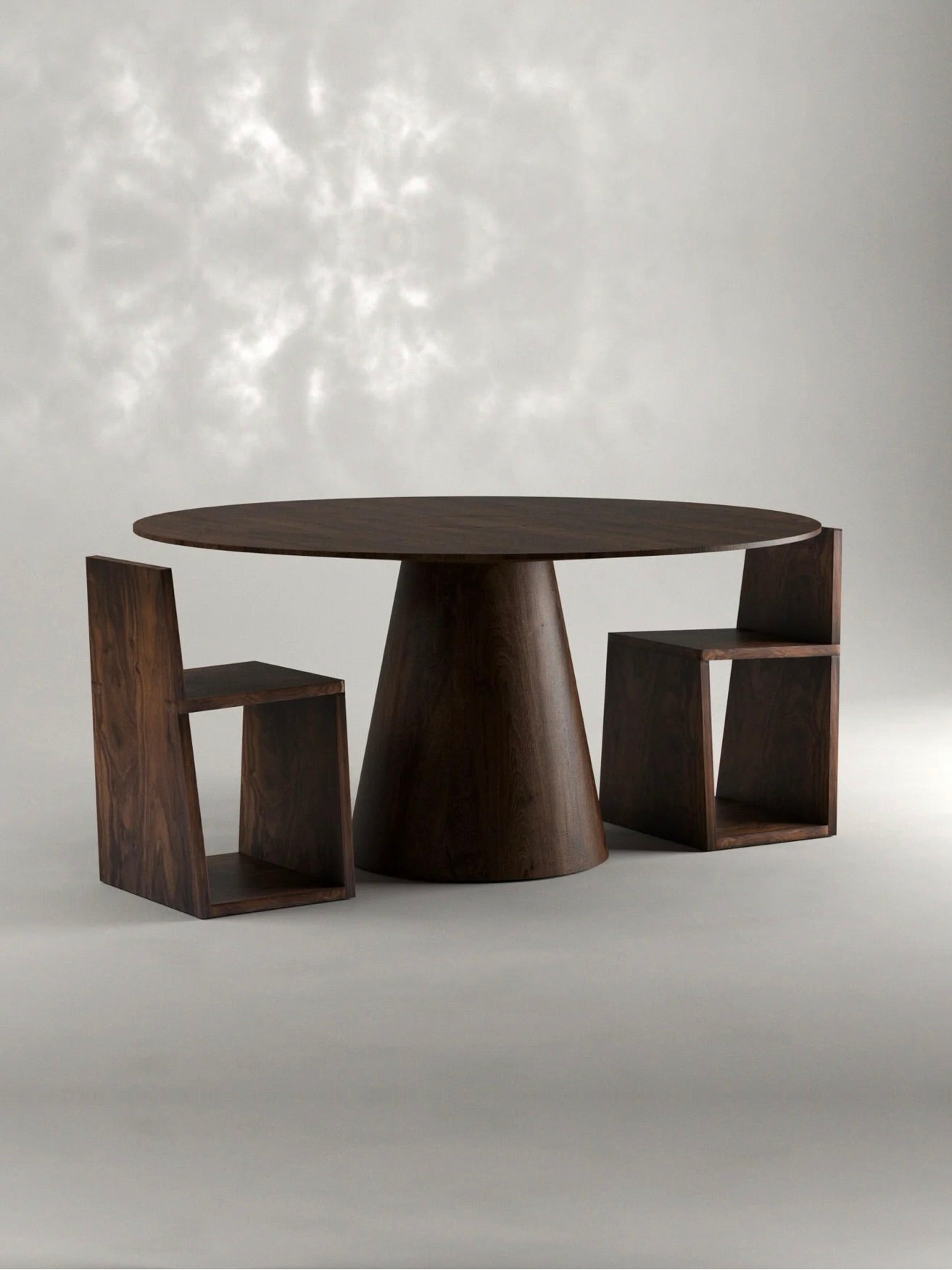 Discover the 'Totem' Dining Table by Siete Studio, a minimalist dining set with a handcrafted solid walnut round table and tapered base. It comes with two geometric chairs, all set against an elegant neutral gray background for enhanced simplicity.