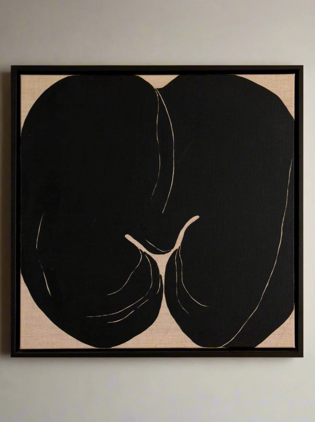 Abstract monochrome artwork of two faces in profile, their outlines merging to form a single shape against a black background, framed in a simple black wood frame by Alba Hodsoll Studio's Superseed I.