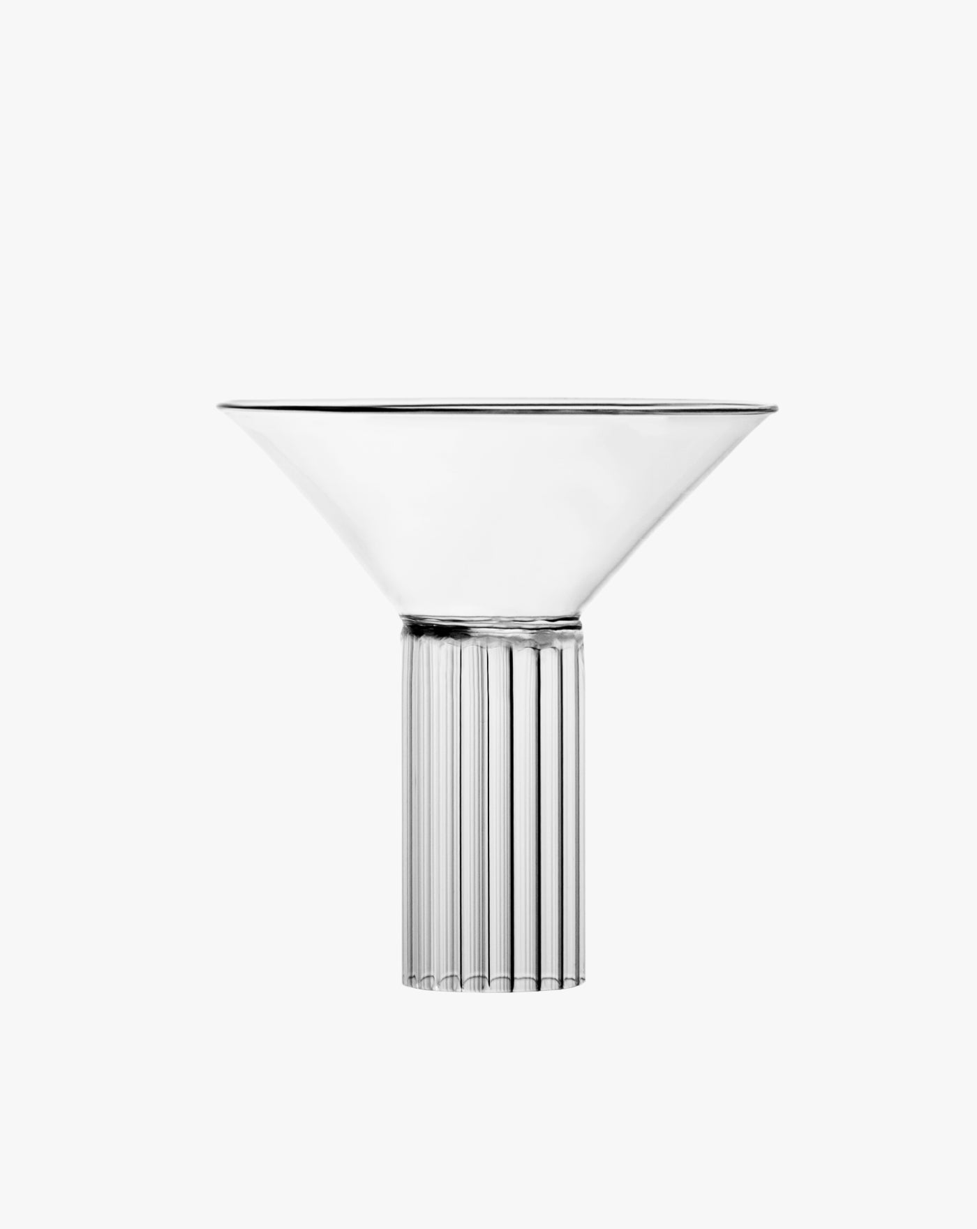 A Calici Milanesi Cocktail Glass with a wide, conical top and a ribbed cylindrical base, displayed against a pure white background by Agustina Bottoni.