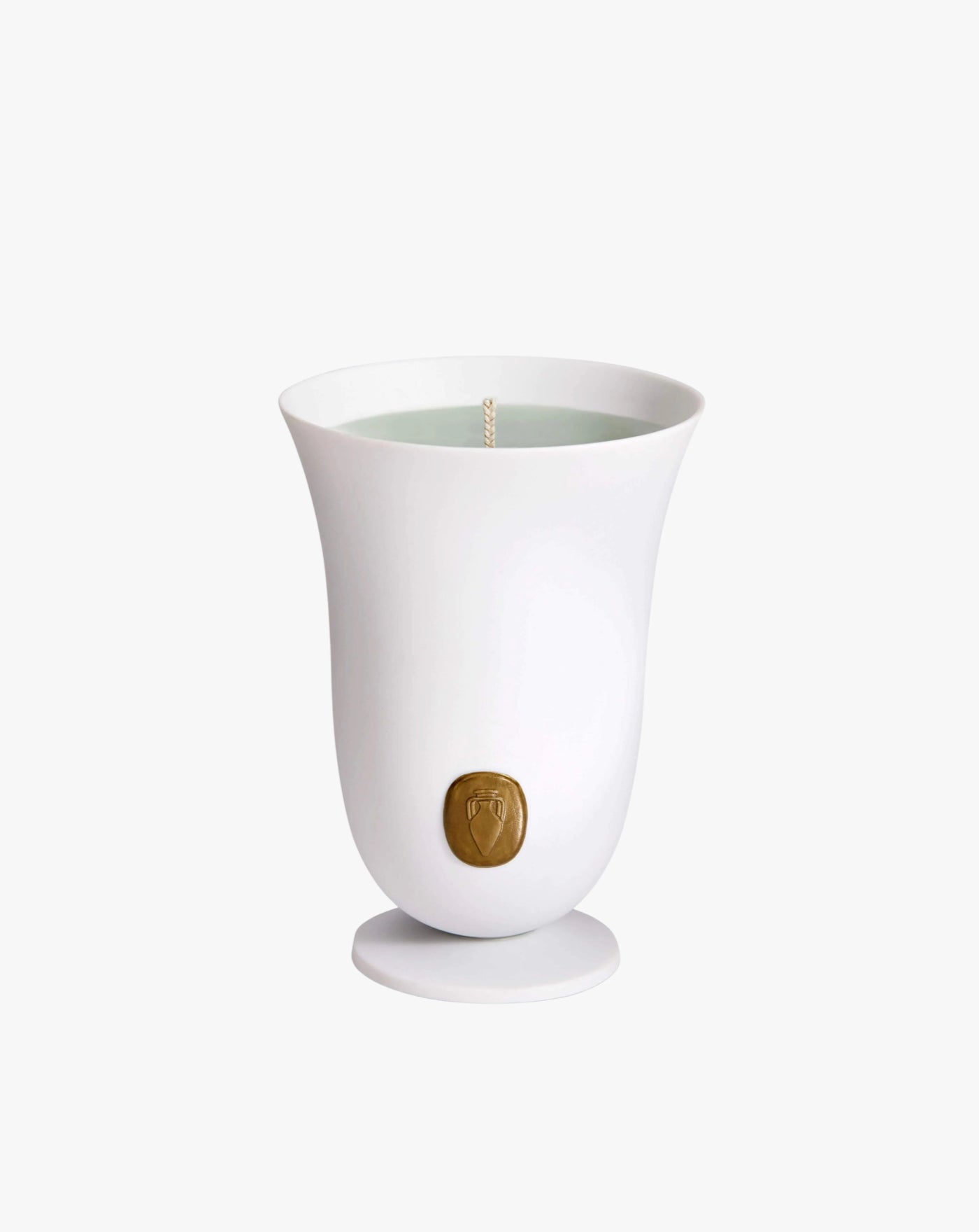 A Bois Vert Candle from LOBJET in a tulip-shaped vessel with a wick at the center and a small, round, embossed golden seal near the bottom on an isolated white background infused with Egyptian geranium.