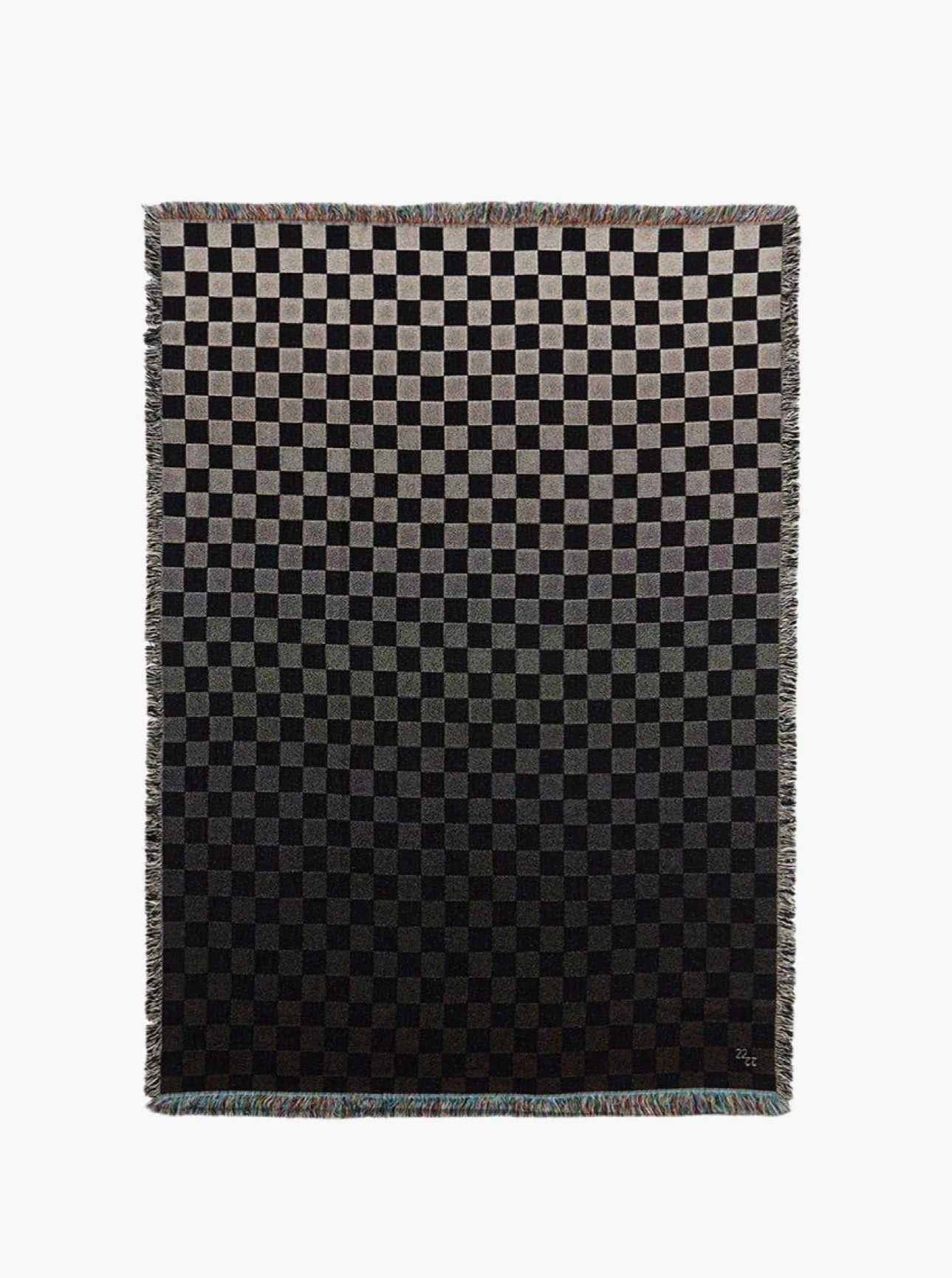 A gradient checkered Iki Jacquard Cotton Throw transitioning from light grey at the top to black at the bottom, displayed against a white background.