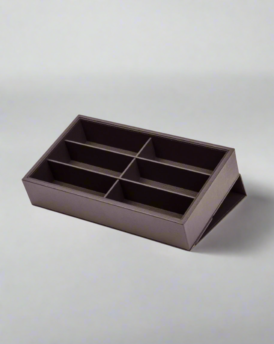 A brown Italian calf leather Eyeglasses Box by Pinetti with six compartments, arranged in two rows, against a white background.