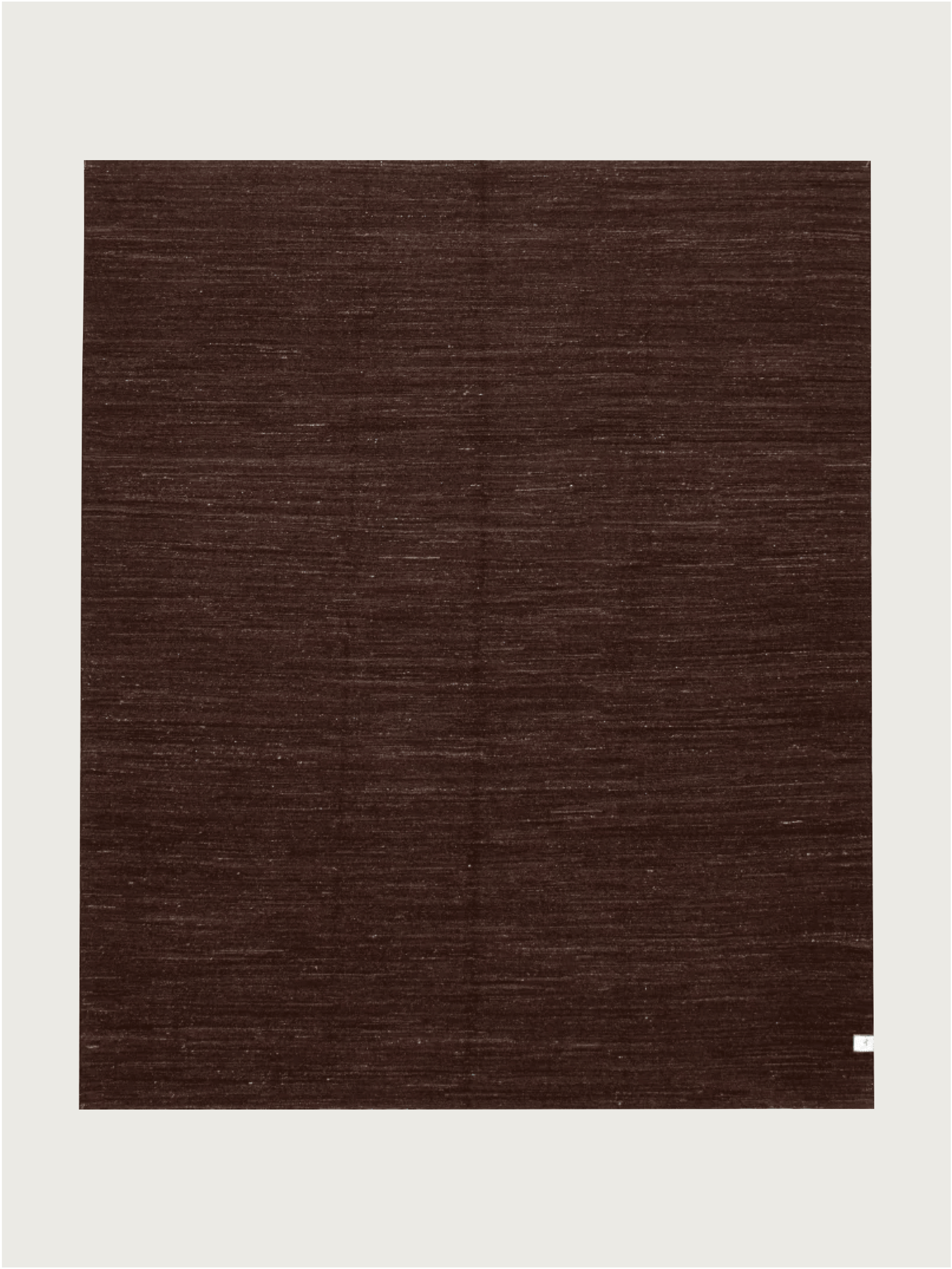 A unique large square Flatweave Rug in Walnut (244 x 292 cm) by catalog:three, set against a light background. It features a subtle weave pattern with a small white label in the bottom right corner, showcasing its wool hand-woven kilim craftsmanship.