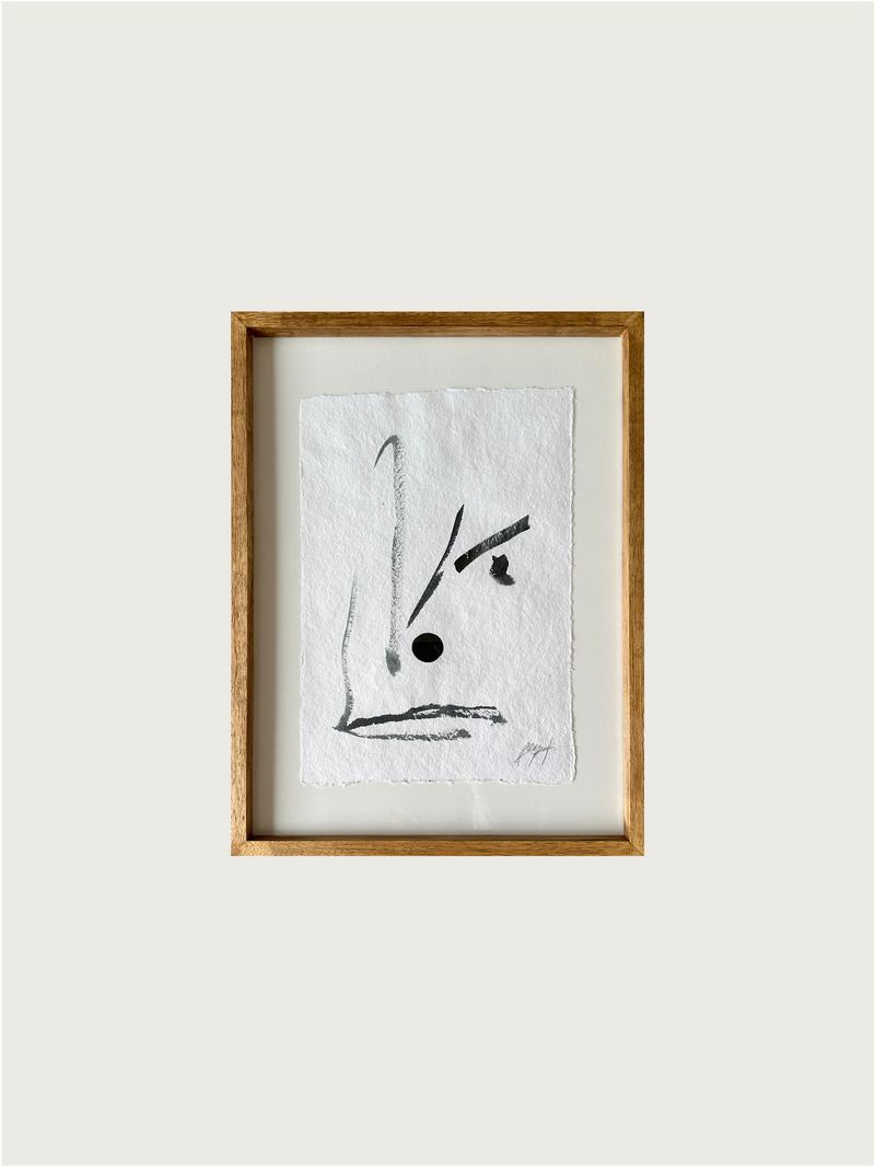 Abstract black ink brushstrokes on textured white paper, framed artwork