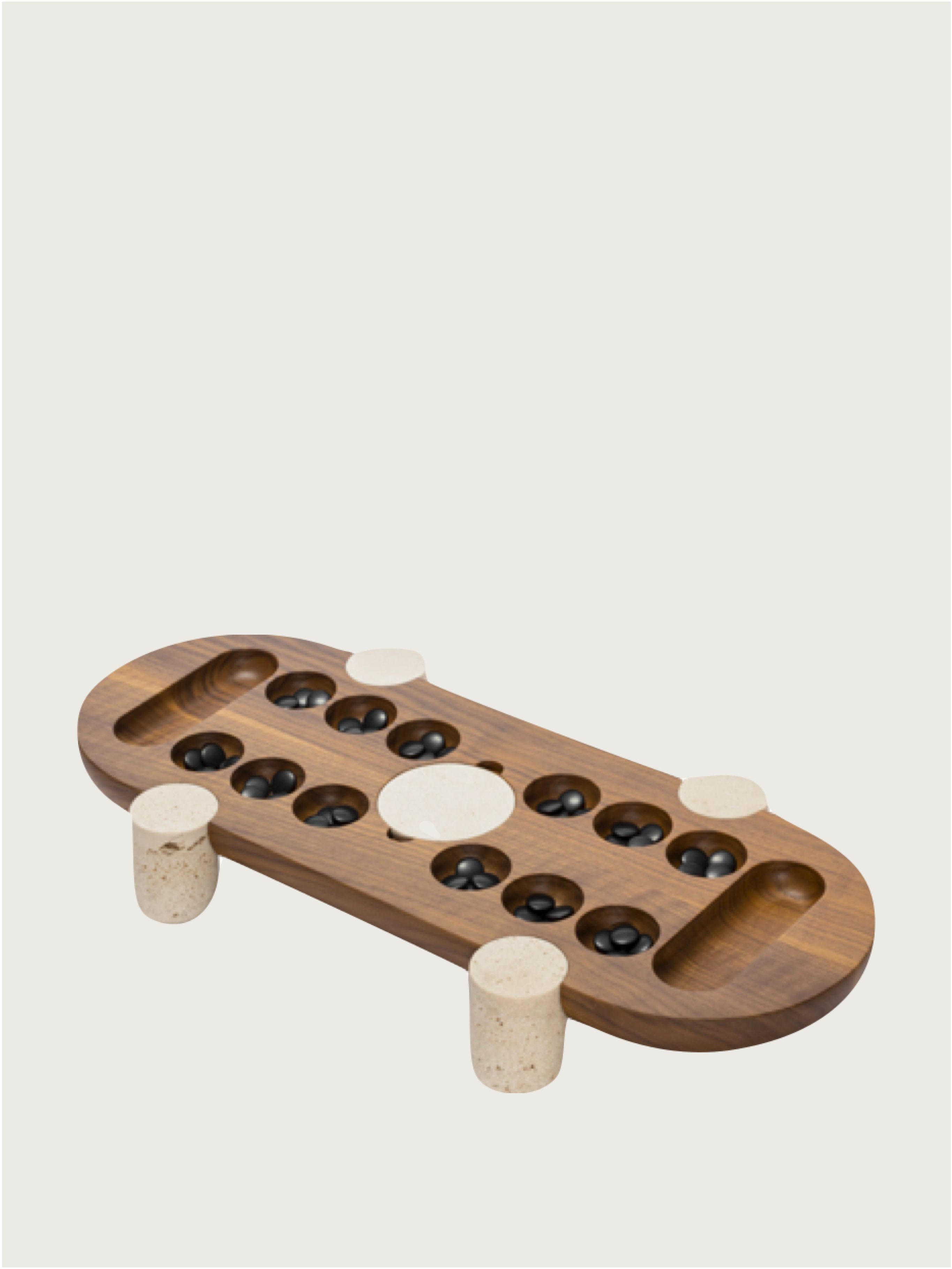 The MOCAMBO Wari Game Set by GIOBAGNARA features a solid walnut top, marble legs, small cups with black stones, and a central white marker—crafted with minimalist elegance reminiscent of Simone Fanciullacci.