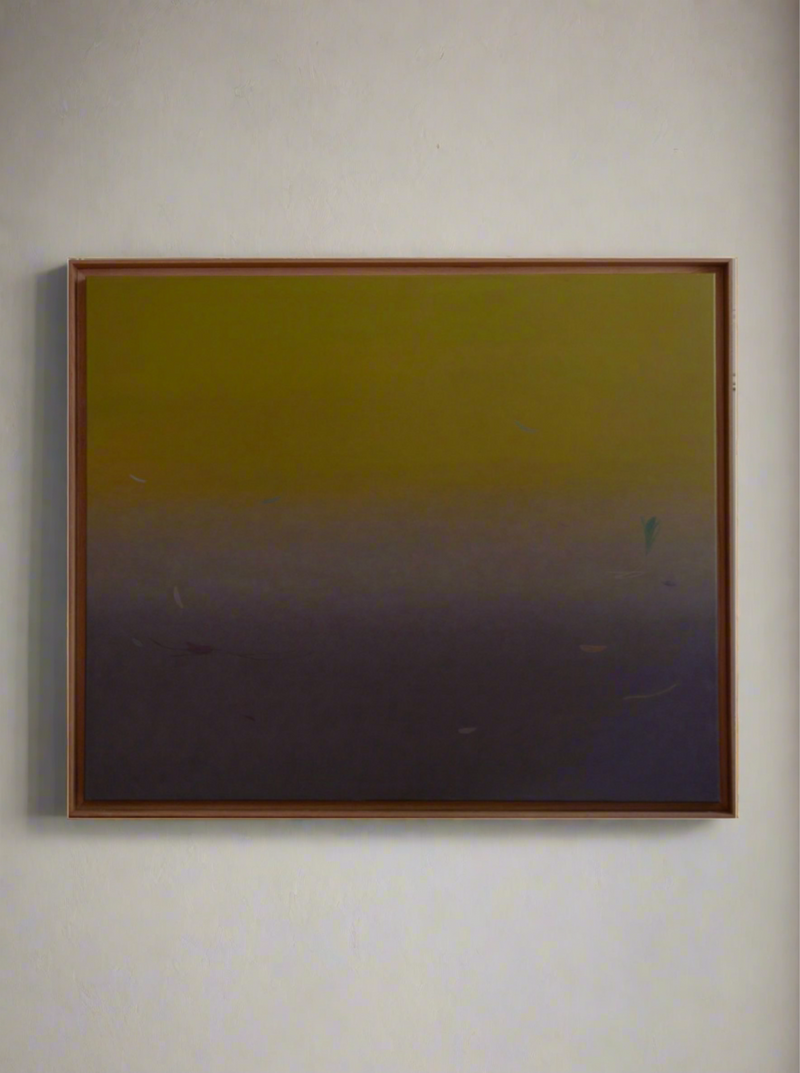 A framed Thru and Thru #2 acrylic painting with a smooth gradient transitioning from dark gray at the bottom to a muted yellow at the top, displayed on a plain background by Rebecca von Matérn.