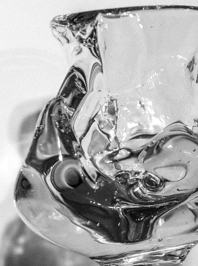 Handcrafted footed blown glass vase in a unique teardrop shape