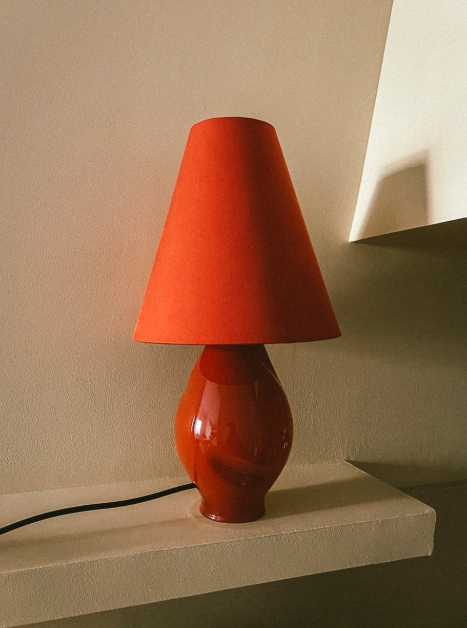 Dark red-conical glass lamp with intricate swirling patterns and gold trim