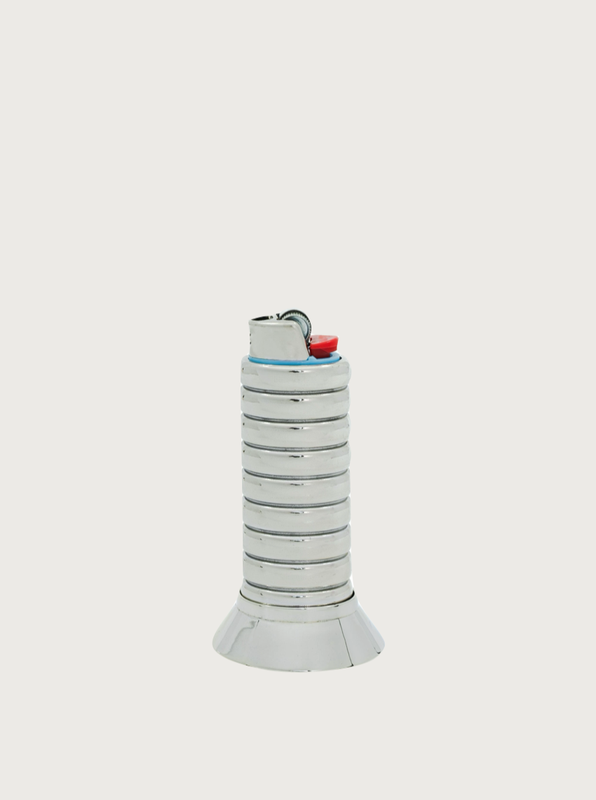 A silver, cylindrical FRY POWERS Gio Lighter Holder with a ribbed texture and a tapered base. The top features a small blue and red button, with a black wire looped from the top. This stylish lighter accessory is set against a plain white background.