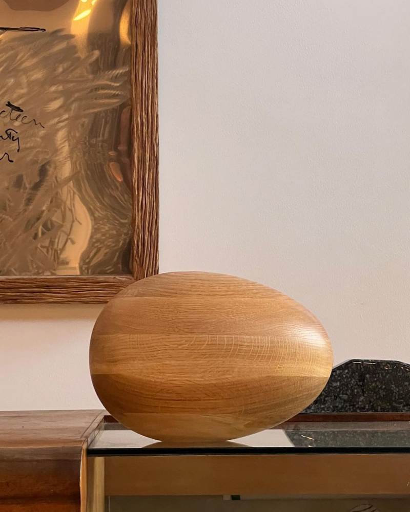 Natural Oak Egg Sculpture displayed on a white background with soft lighting, highlighting its smooth and organic shape, perfect for adding a touch of nature to any space 