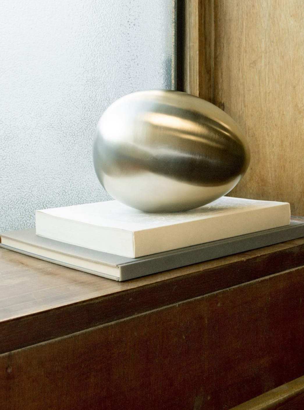 Brushed Steel Egg Sculpture with Abstract Design and Smooth Texture